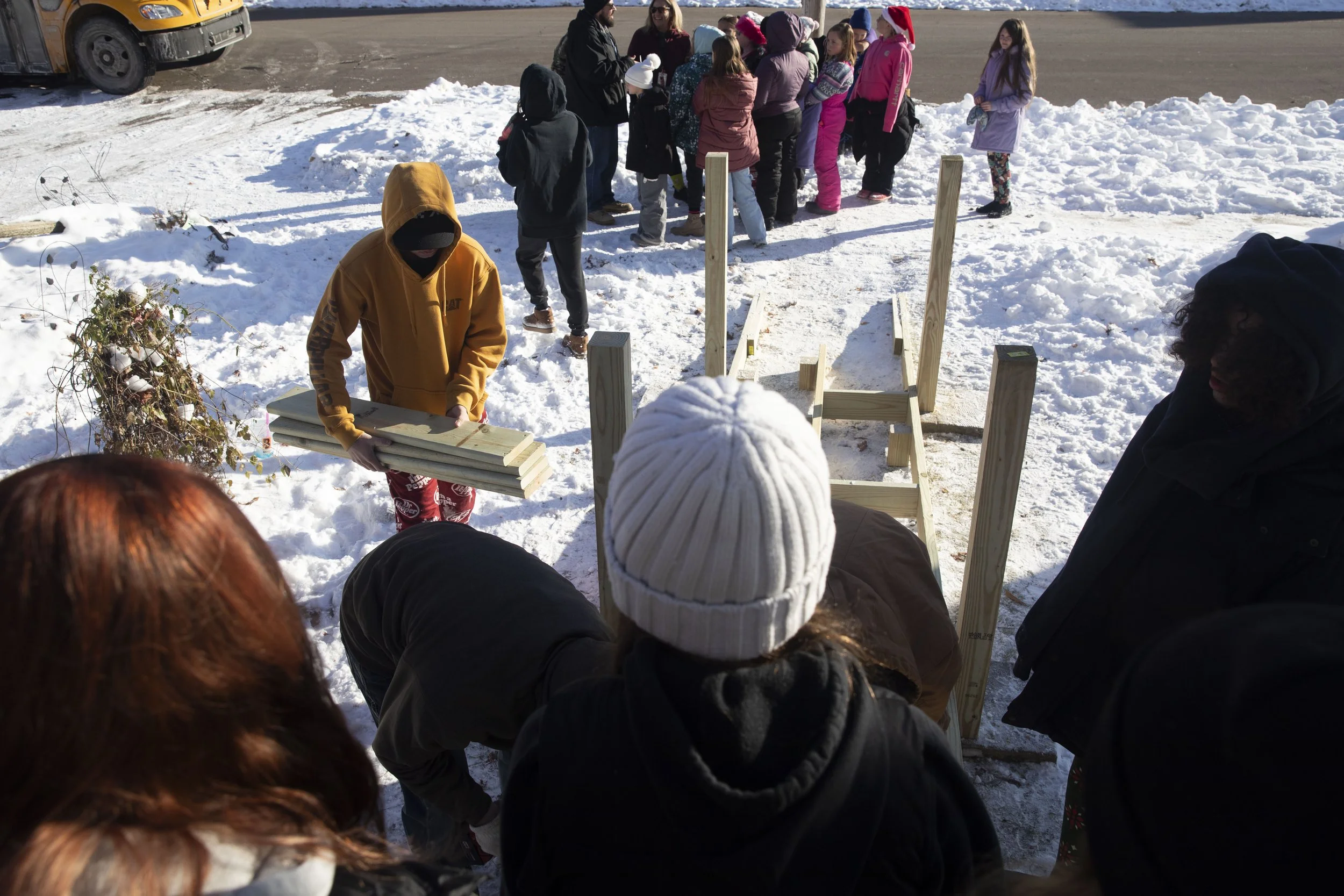 Nevaeh Steers, 10, and her class watch as Concord Middle School’s students work on building a ramp for a her father who became disabled after a crash a year ago. Mike Arbuckle, an industrial arts teacher at Concord Middle School lead the project and 