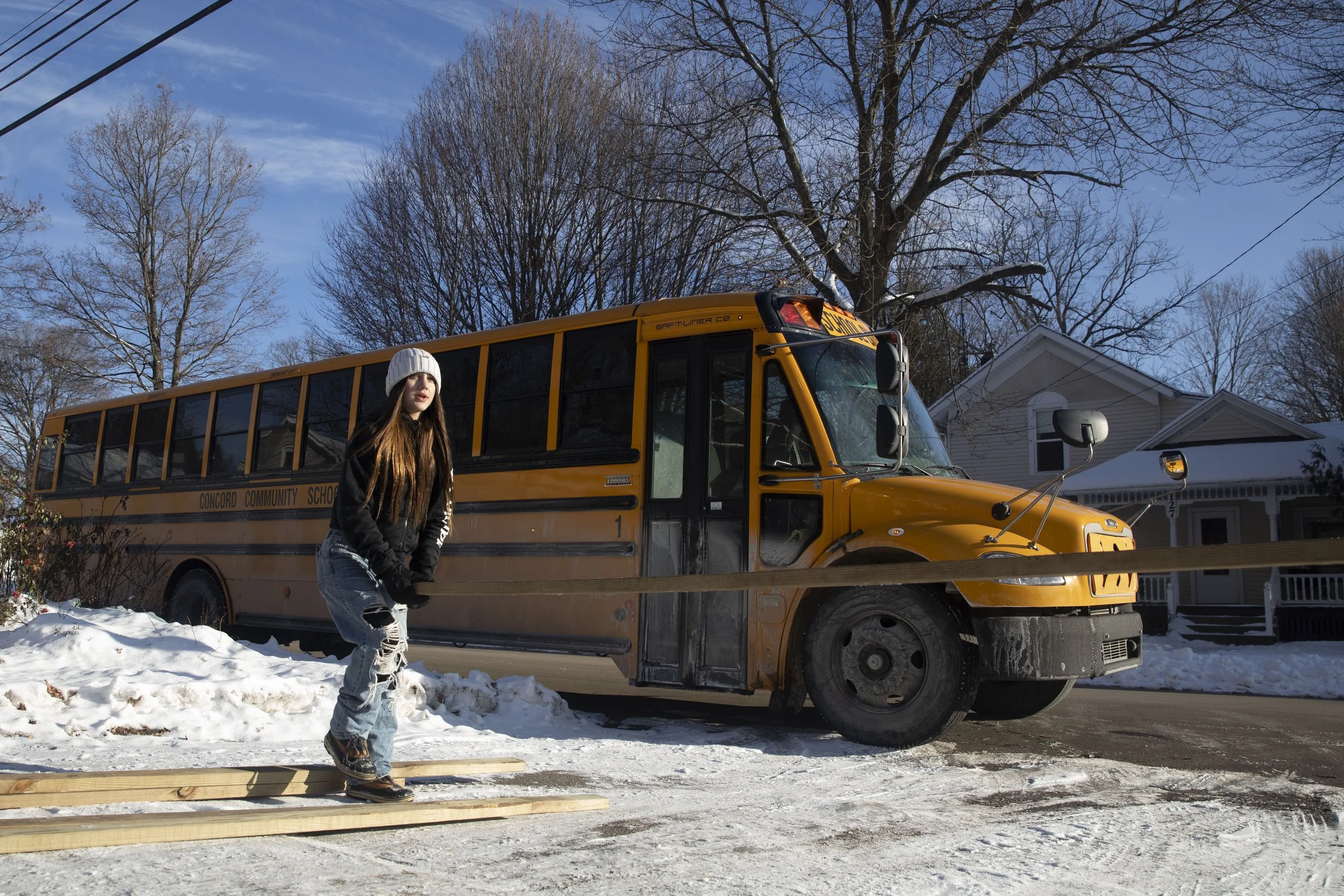 Gabby Becker, 13, works on building a ramp for a student's father who became disabled after a crash a year ago. Mike Arbuckle, an industrial arts teacher at Concord Middle School lead the project and installment outside of the home on S. Concord St.,