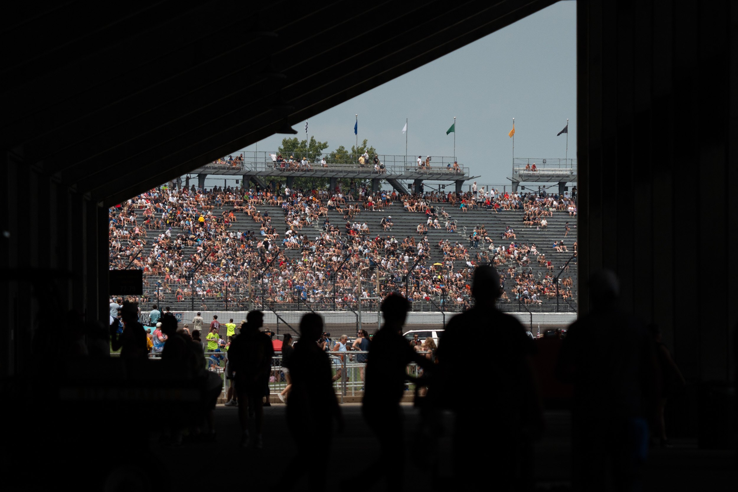 The crowd in the stands watch as cars fly by during the race at the Brickyard 400 on July 26, 2026 at the Indianapolis Motor Speedway.