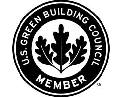 U.S. Green Building Council member badge with a black oak leaf in a white circle surrounded by a black ring.