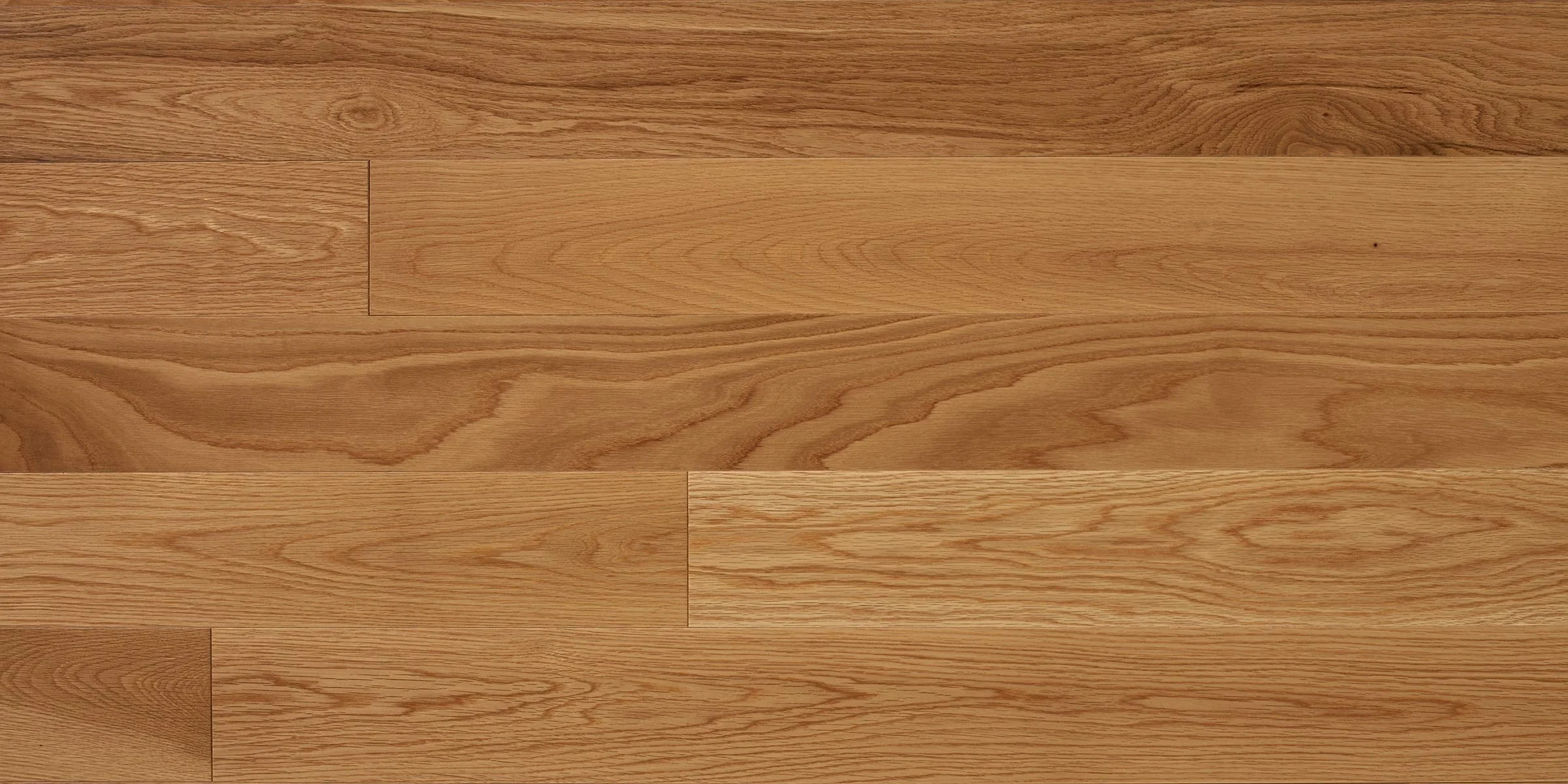 Close-up of a wooden hardwood floor with a natural finish, showing various grain patterns and shades of brown.