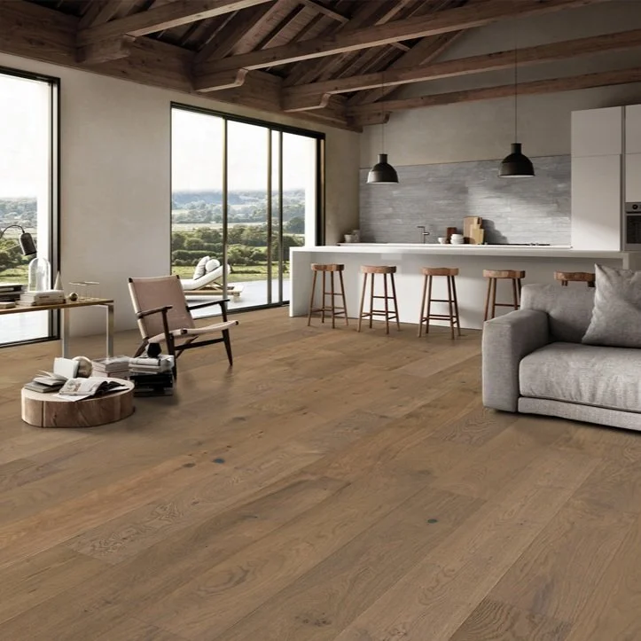 Modern open-concept living space with large windows, wooden ceiling, minimalist furniture, and a kitchen island with bar stools.