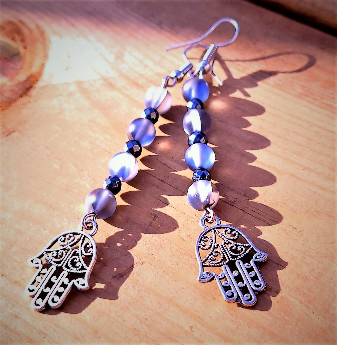 hamsa hand earrings in the light out insta.jpg