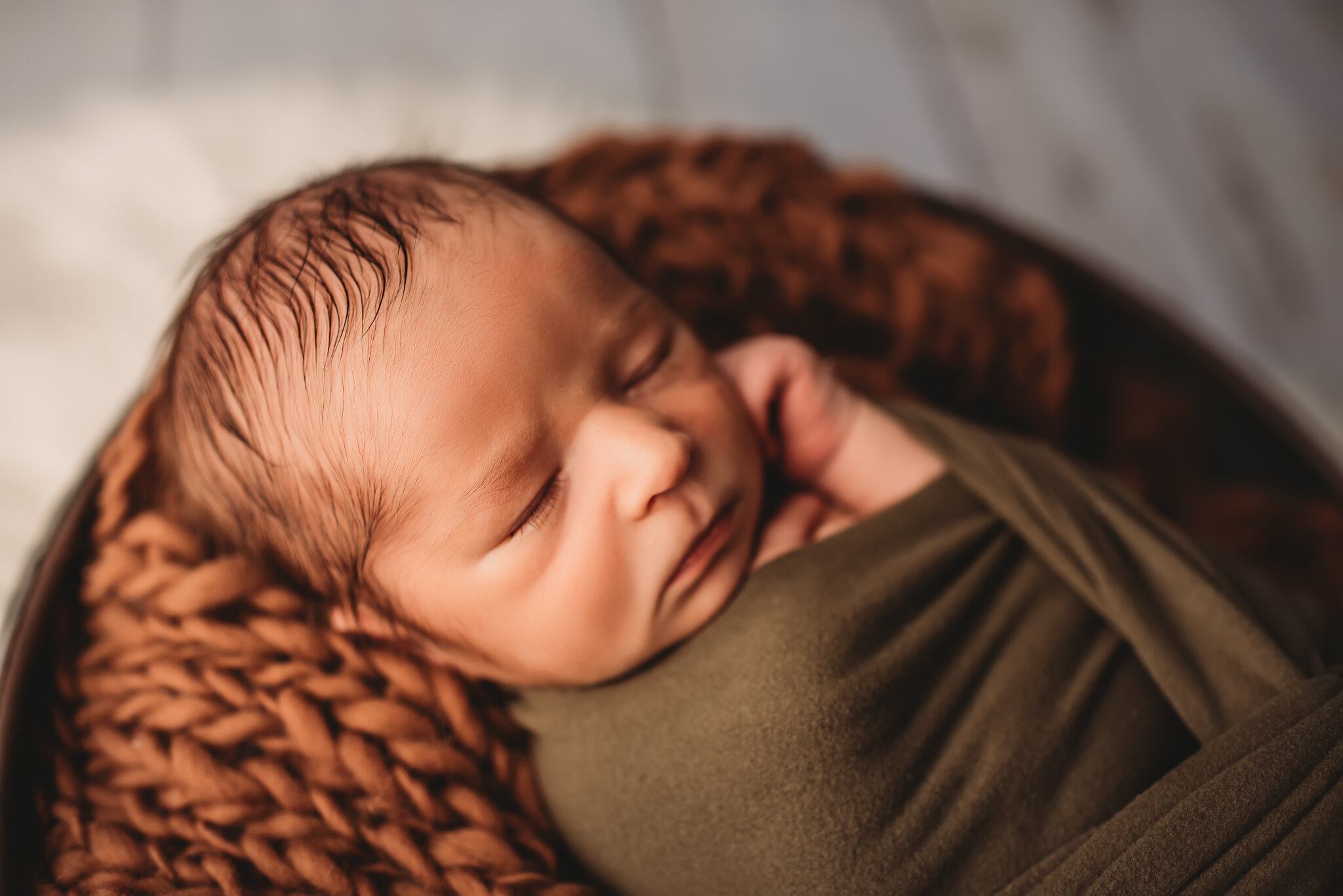 Peoria Newborn Photographer-Baby sleeps on brown braided blanket