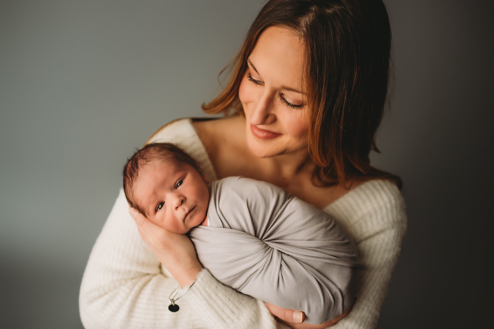 Peoria Newborn Photographer-Mom holds baby