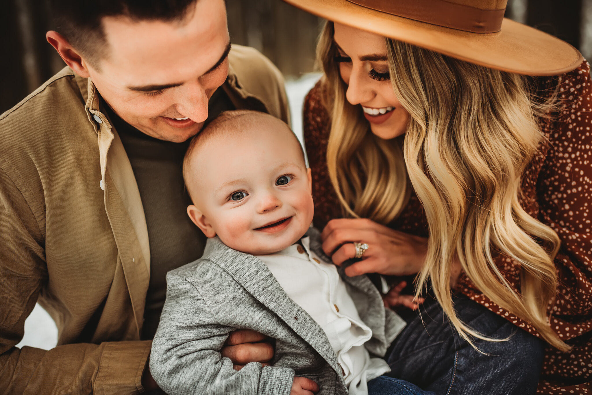 Peoria Family Photographer-Baby smiles at camera while parents tickle
