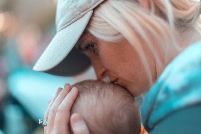 new webpage mom kissing baby.jpg