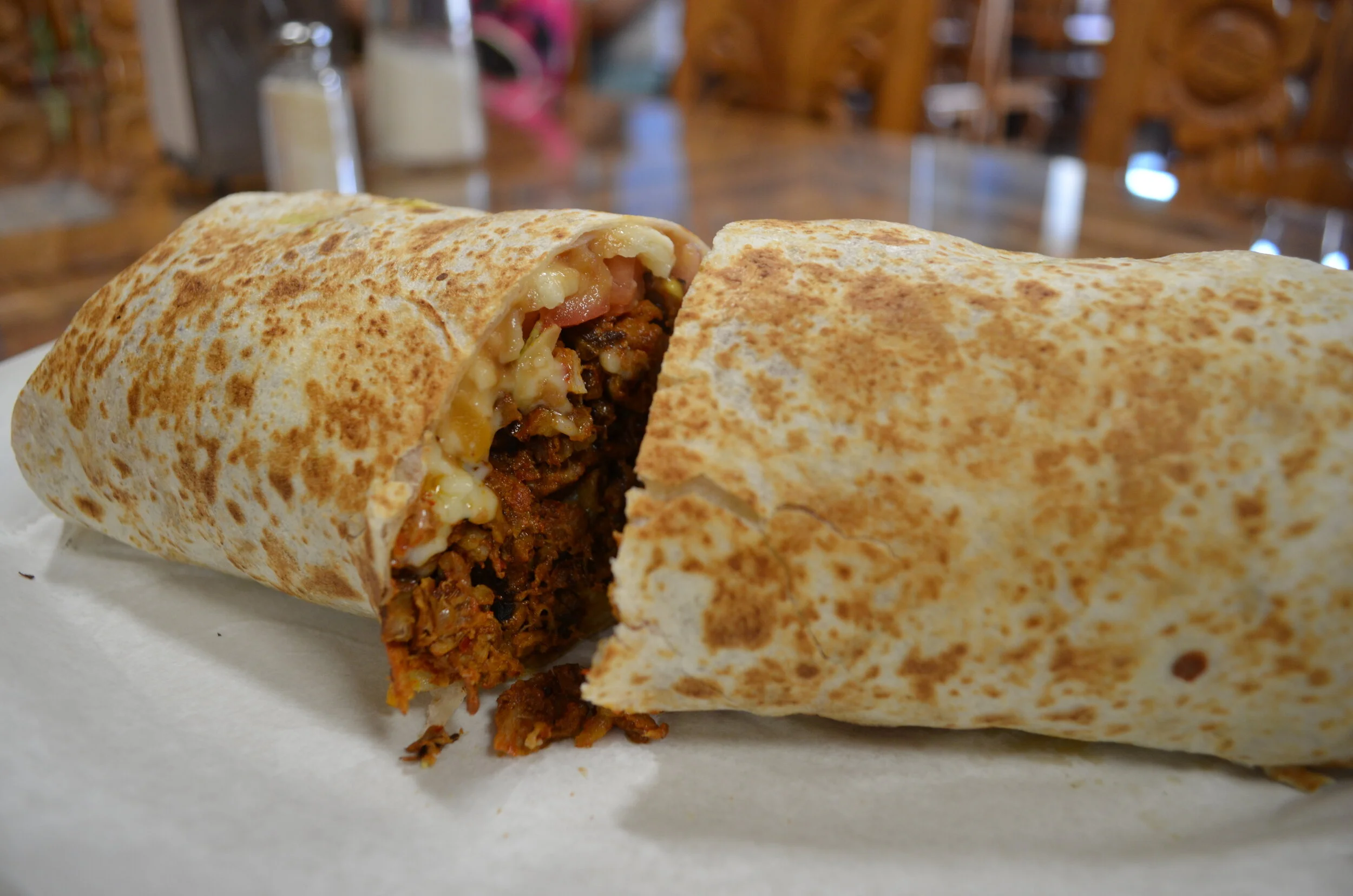   The burritos are also one of the most popular dishes, Bran says. This burrito has pork, melted cheese, tomatoes, lettuce and sour cream.  