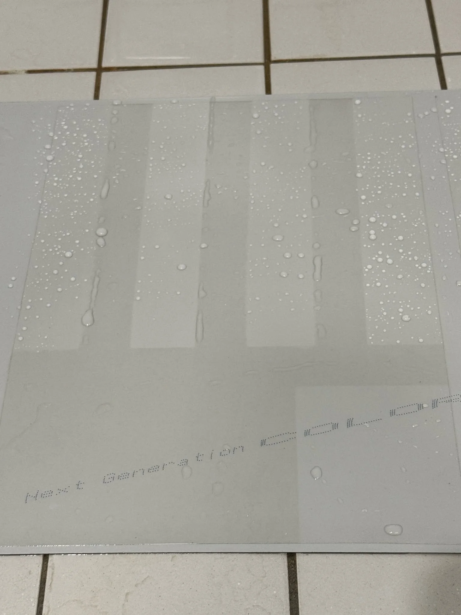 Water beading on ceramic coated paint protection film showing hydrophobic performance