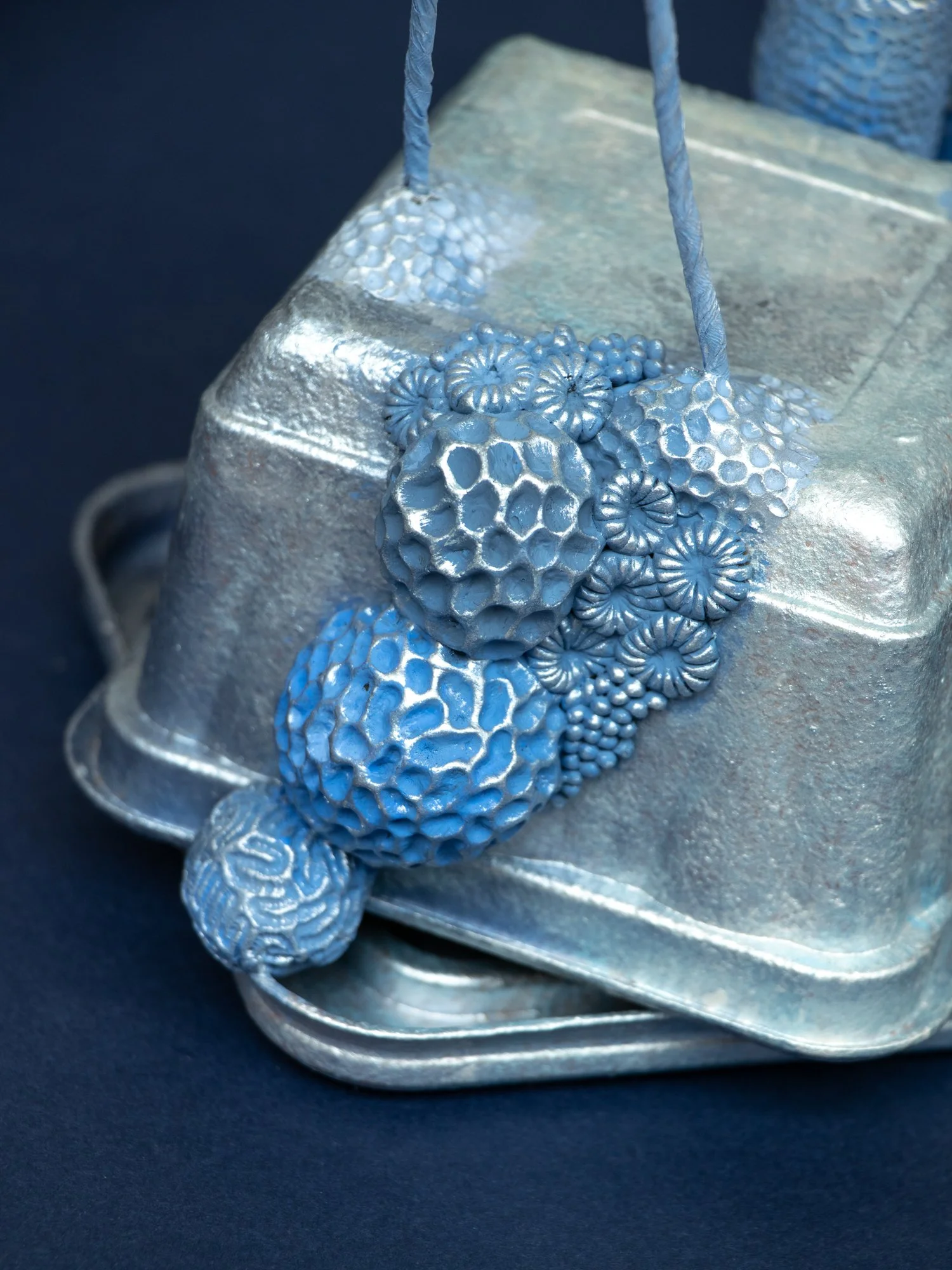 Precarious Balance, Mixed Media Coral and Tripod Fish Sculpture on Trash, 2026, Stephanie Kilgast