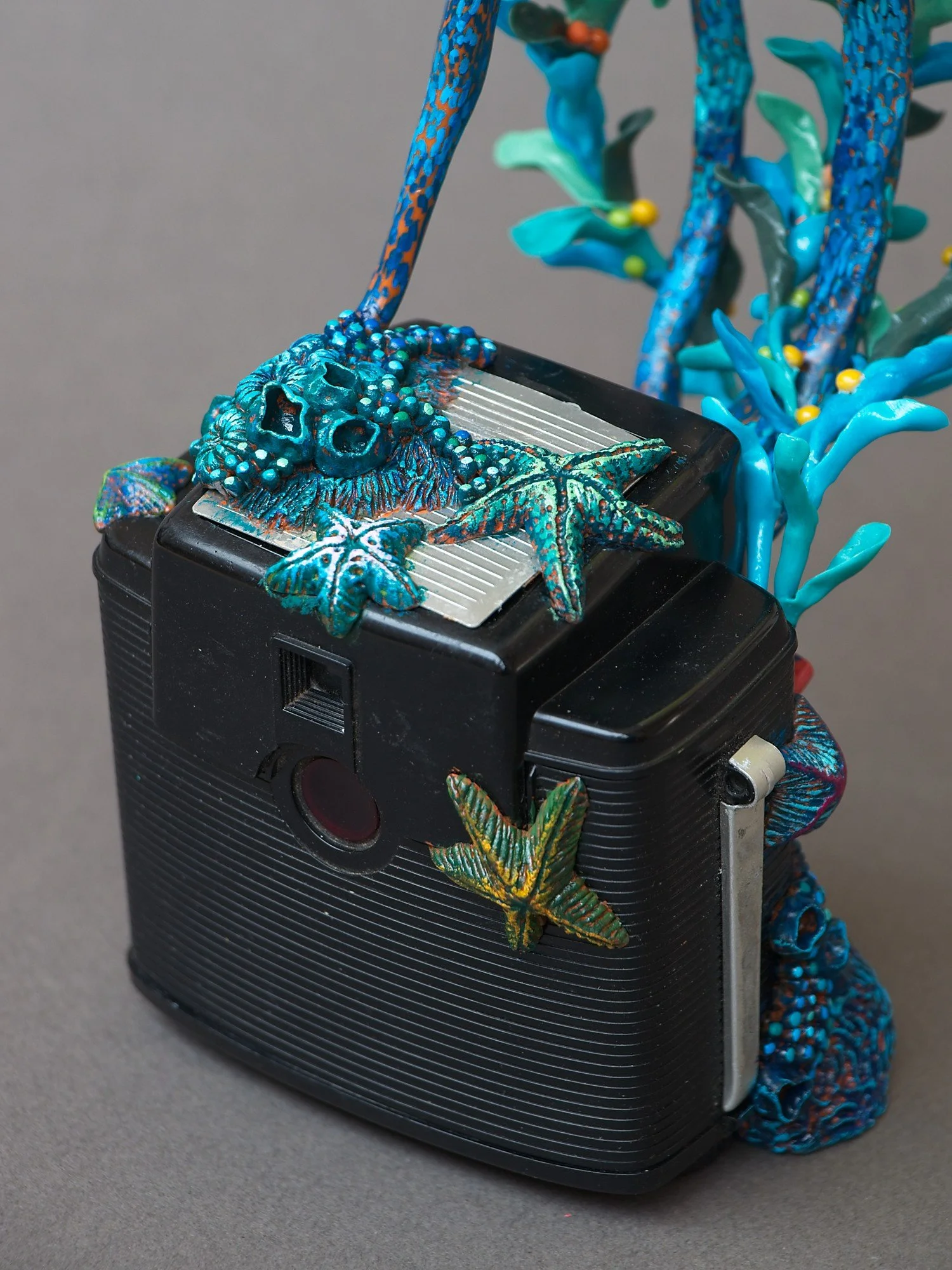 Festive Squid, Miniature Squid Sculpture on Vintage Kodak Camera, 2026, Stephanie Kilgast