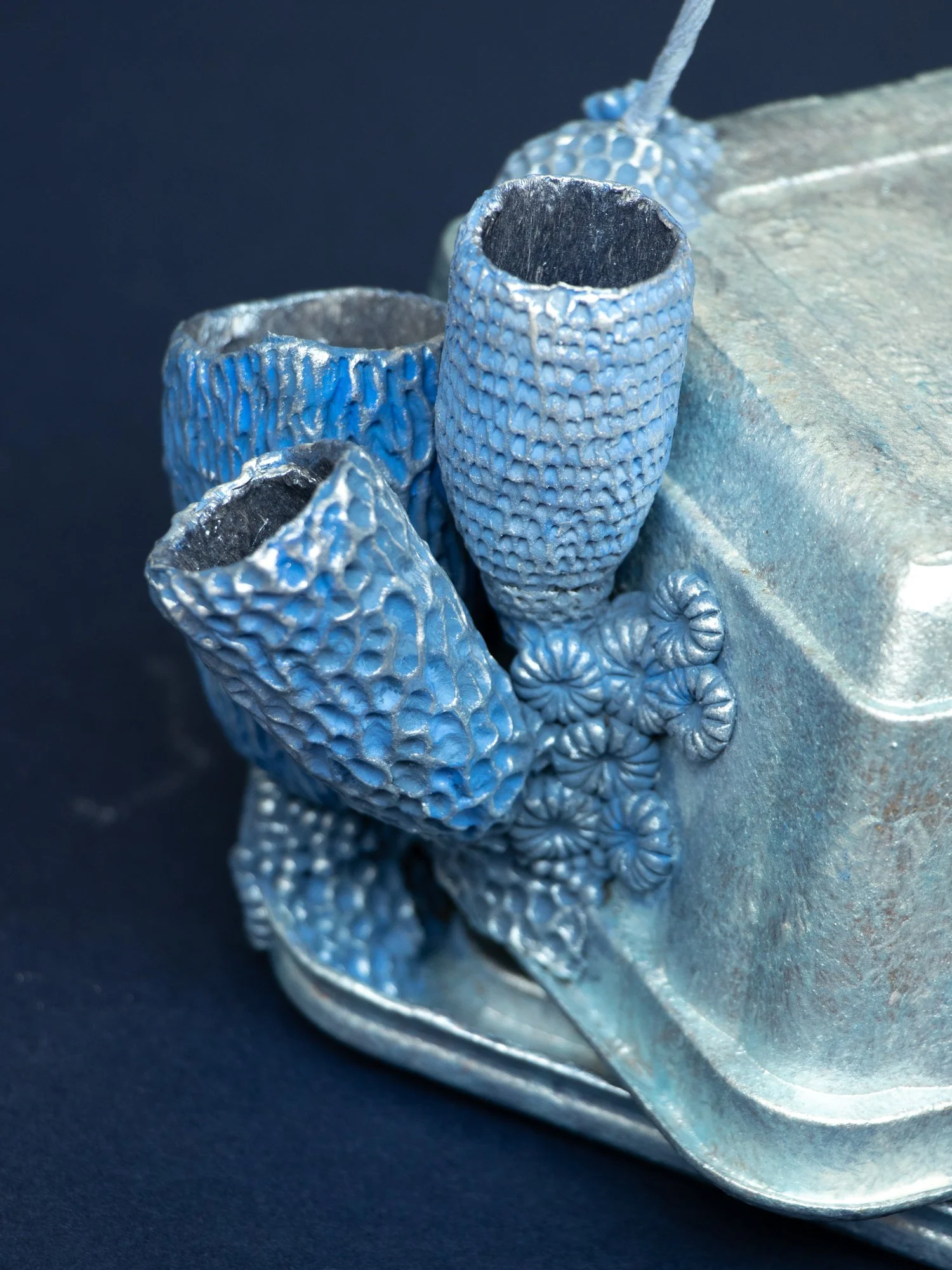 Precarious Balance, Mixed Media Coral and Tripod Fish Sculpture on Trash, 2026, Stephanie Kilgast