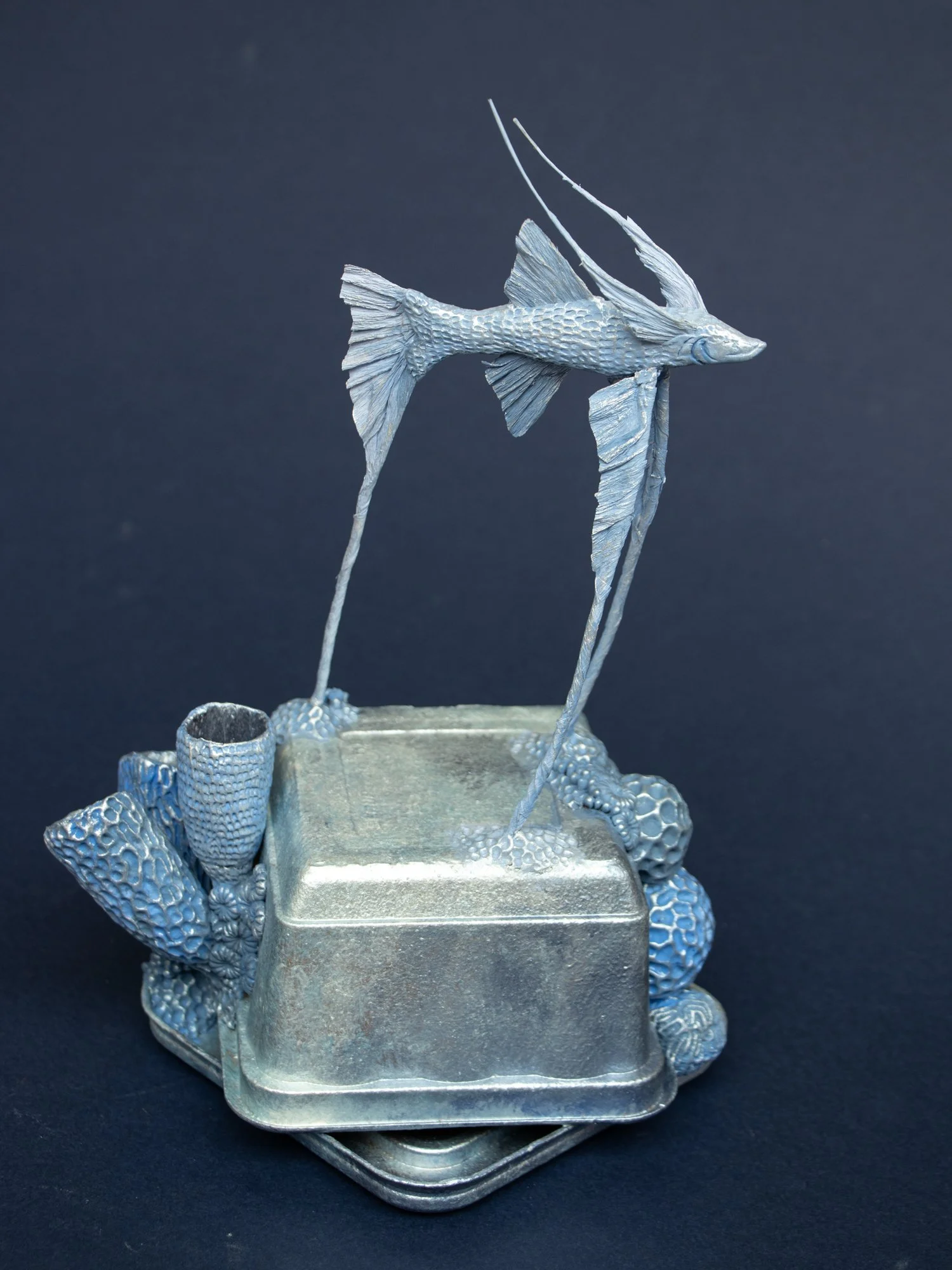 Precarious Balance, Mixed Media Coral and Tripod Fish Sculpture on Trash, 2026, Stephanie Kilgast