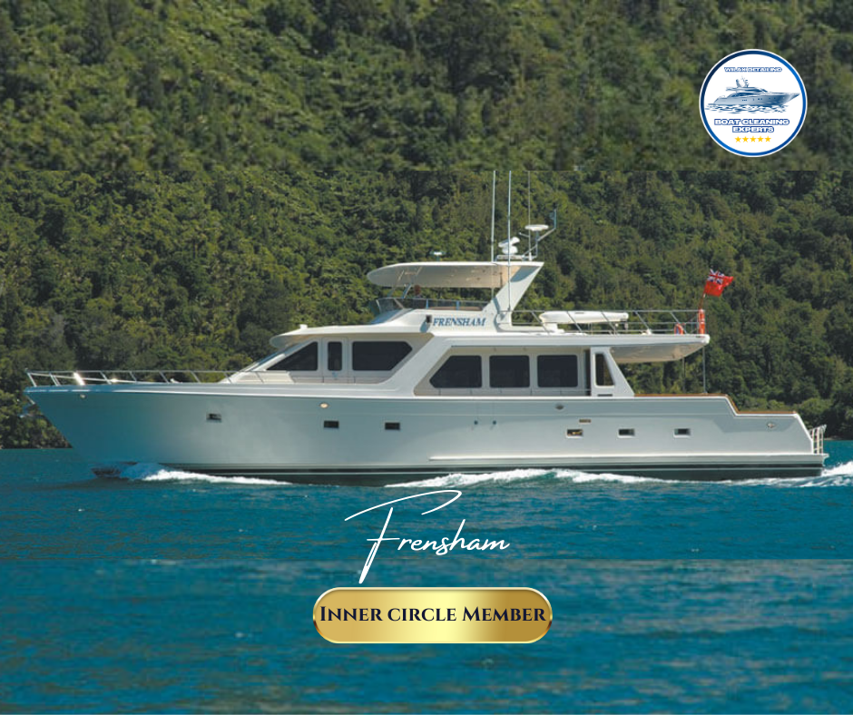 Luxury yacht Frensham Offshore 72' sailing on blue water with a forested background, featuring a Wilax Detailing advertisement for boat cleaning experts.