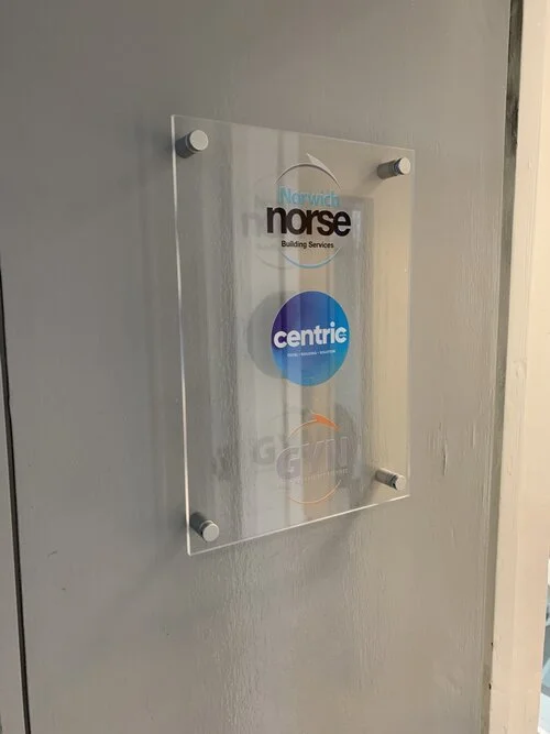 Clear sign mounted indoors with stud fixings