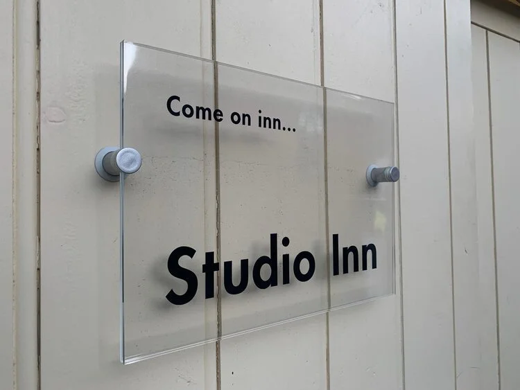 Clear sign mounted on a door with stud fixings