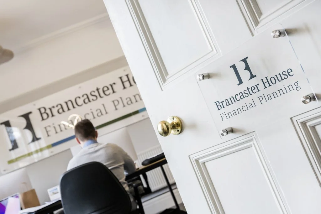 Clear stud fixed sign on a white door