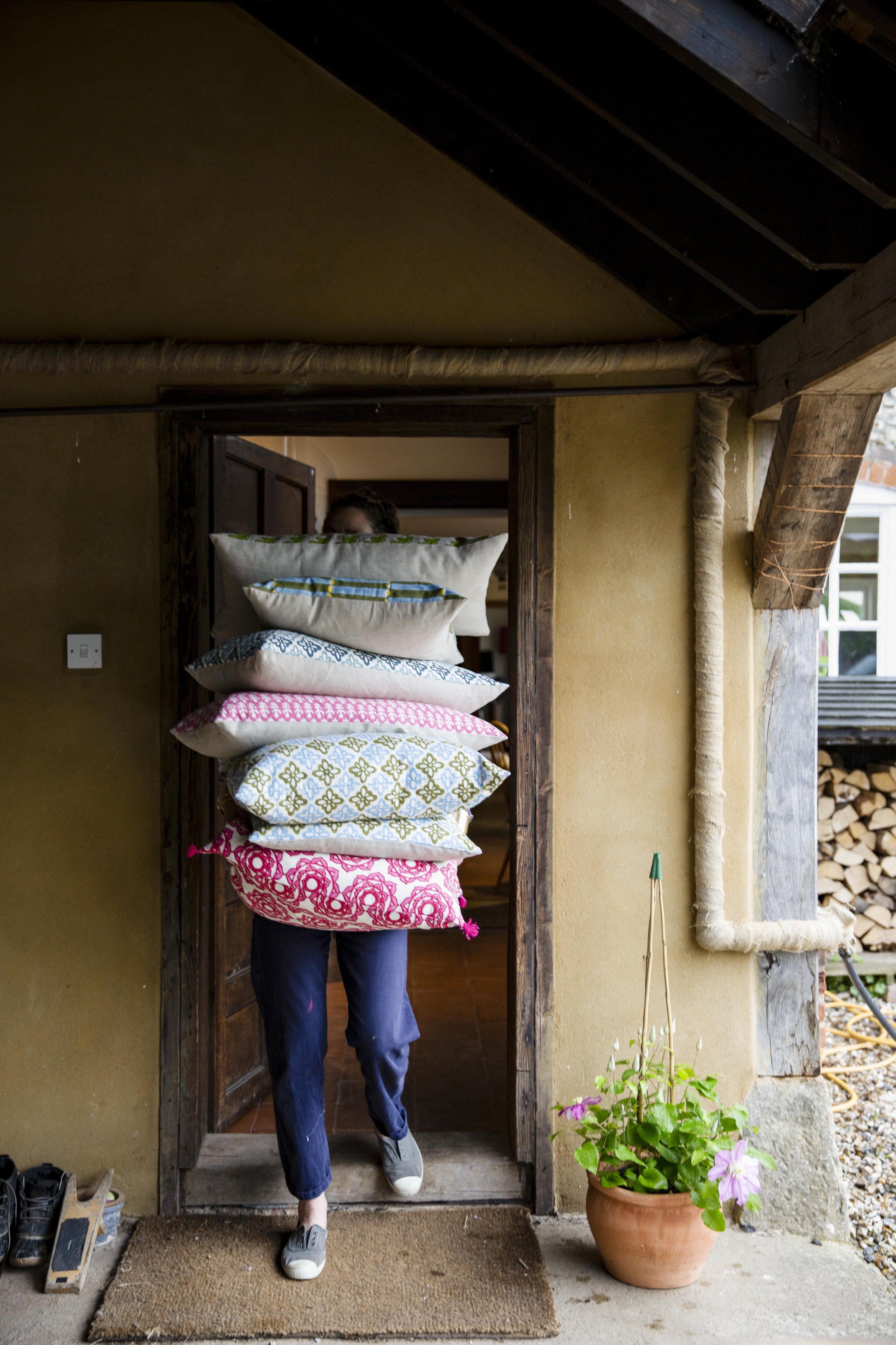 Molly carrying a pile of her cushions-Emma Lewis.jpg