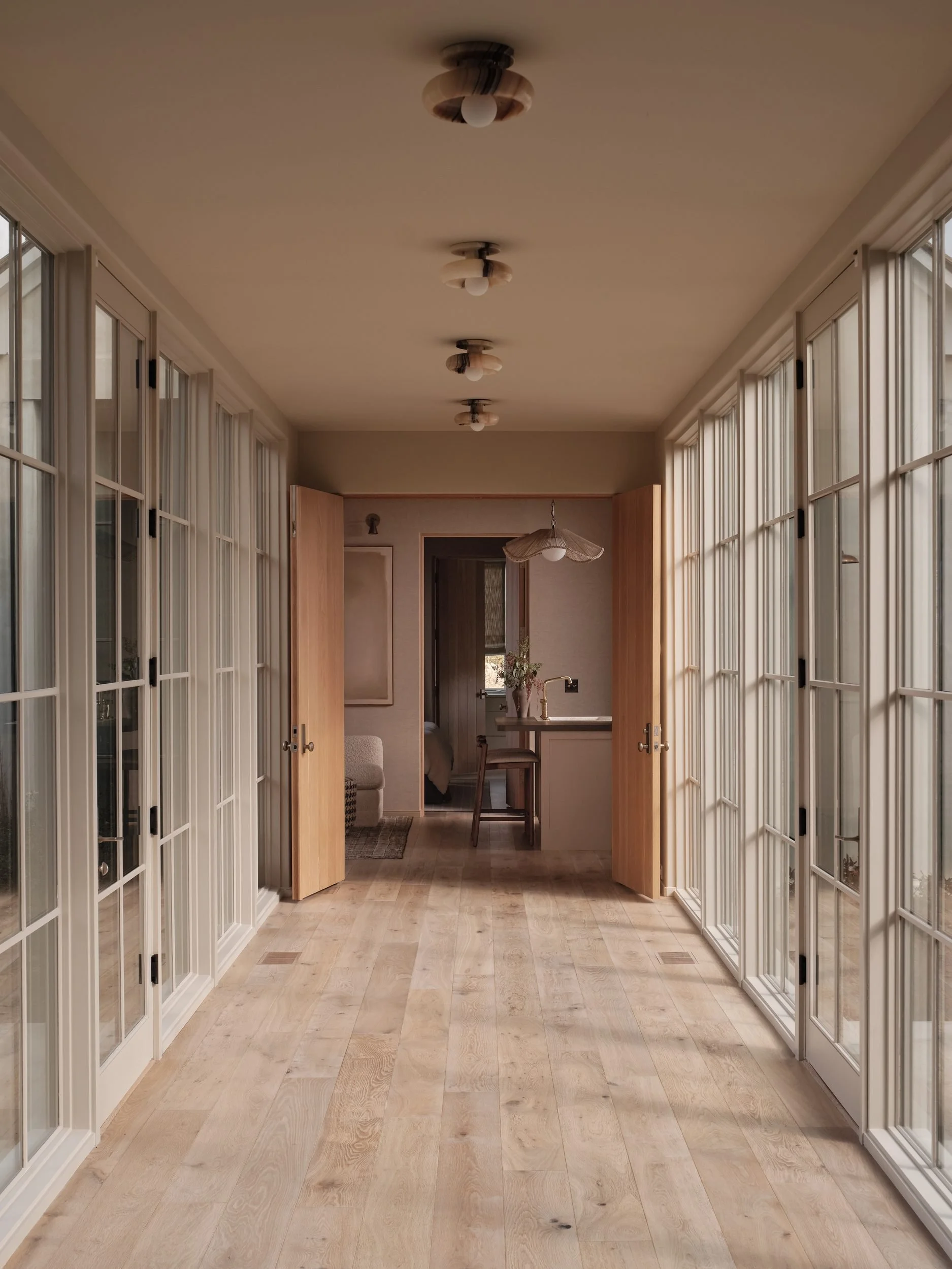 april-tomlin-interiors-compelling-restraint-gallery-hallway-french-doors.jpg