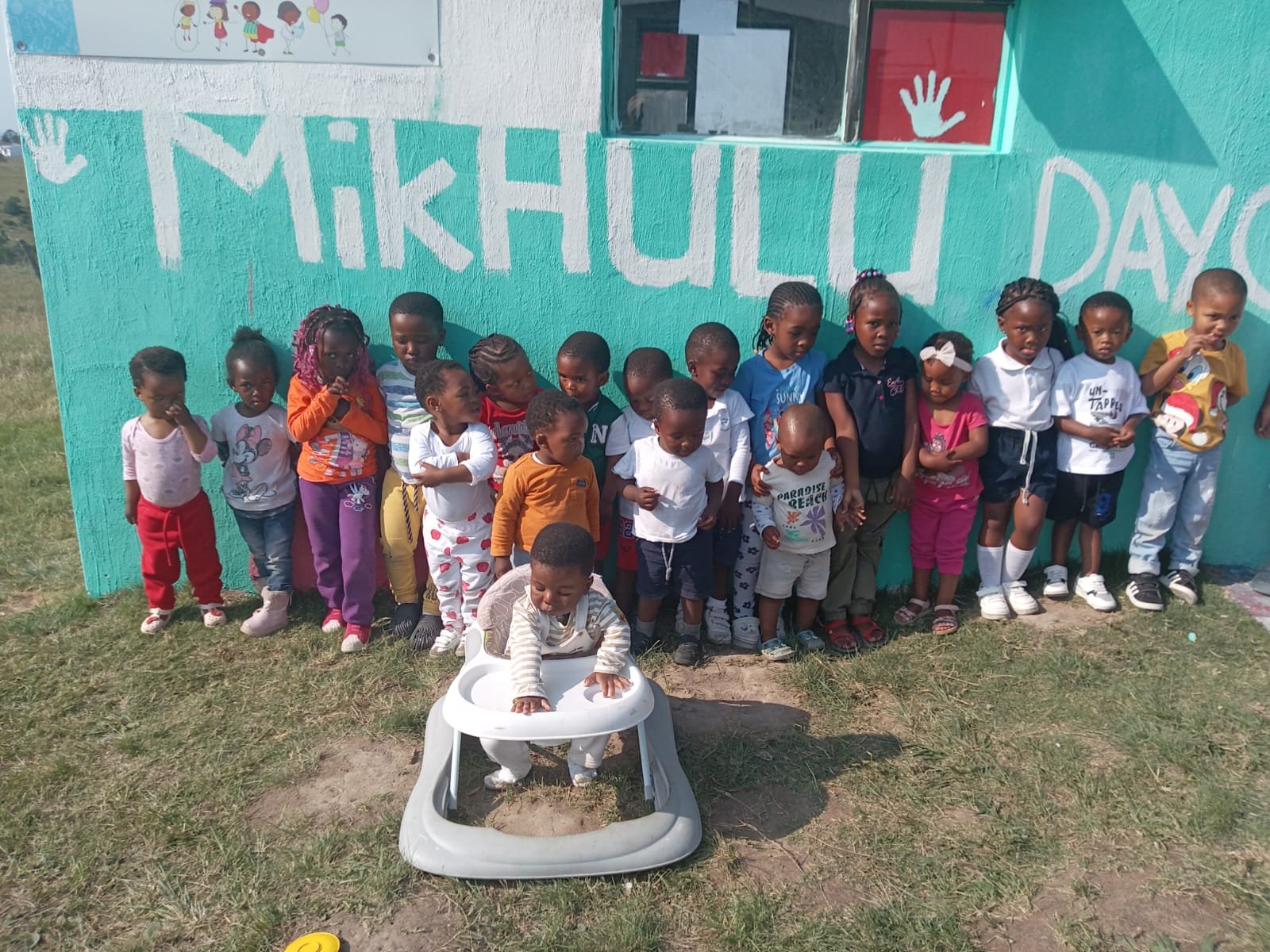 Preschoolers standing in a group outside the old building