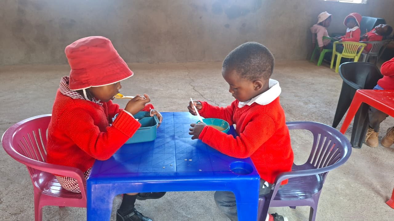 Preschool children enjoying a nutritious meal which improves their health and concentration