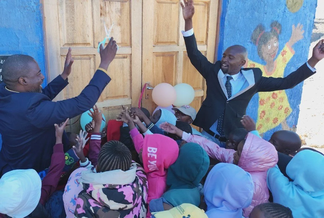 Opening day at Shekinah Preschool in Lesotho with children crowding round the door excitedly