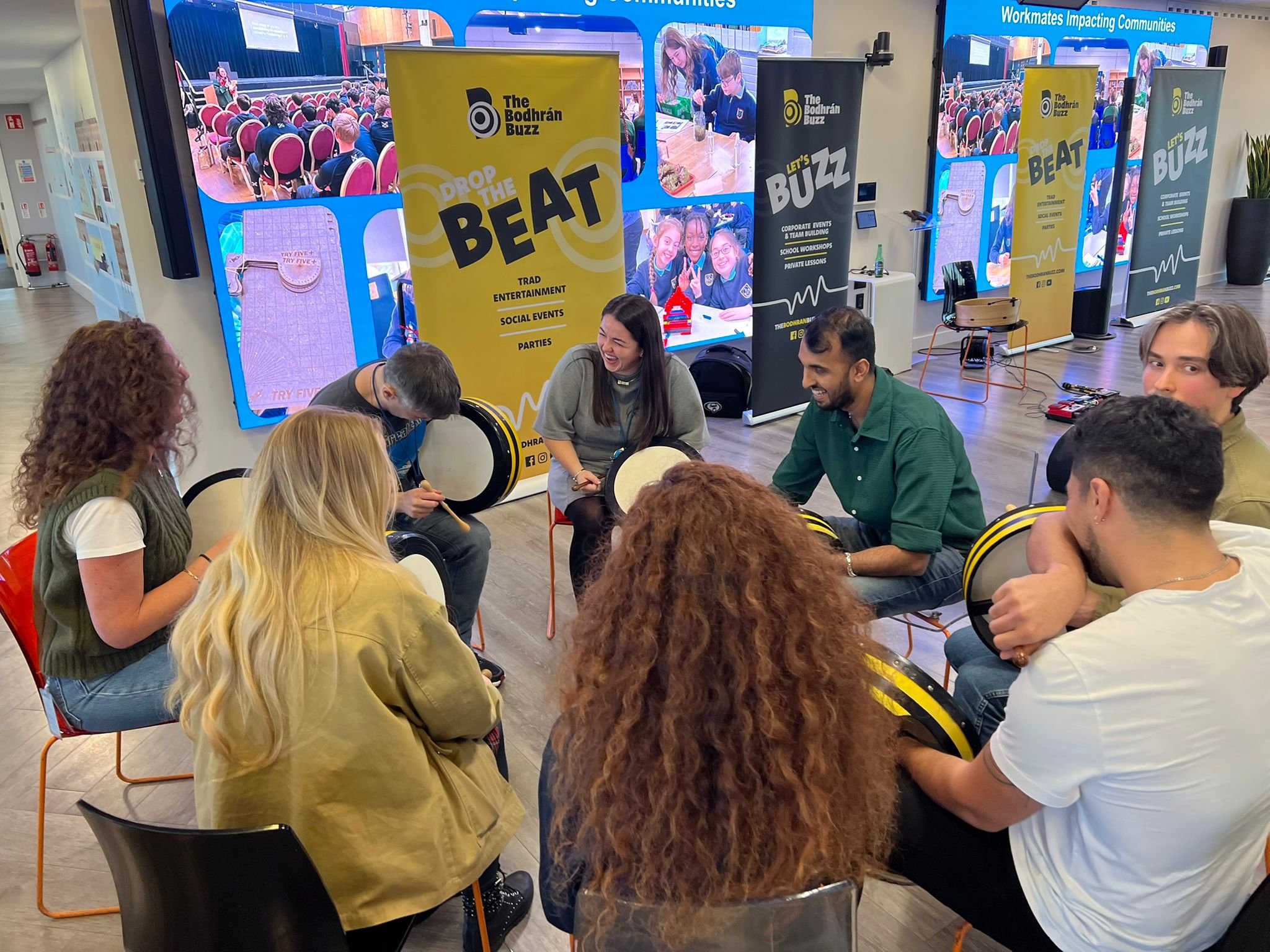 A group of colleagues enjoying a music workshop