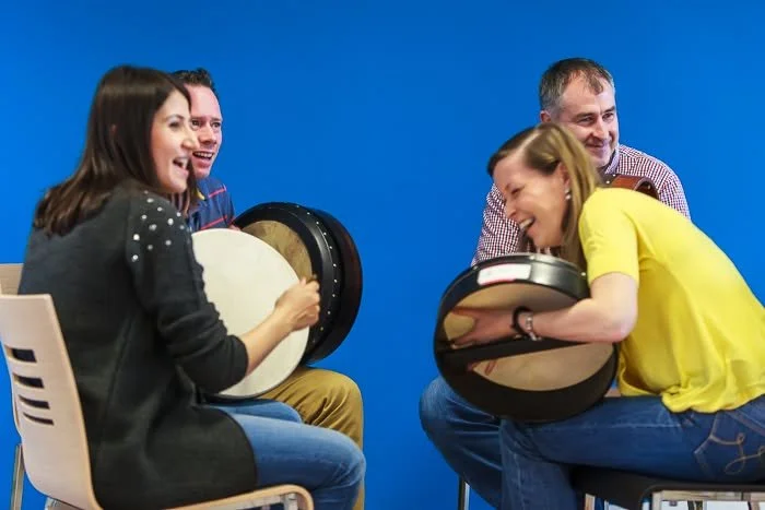 A group of people partaking in a bodhran workshop