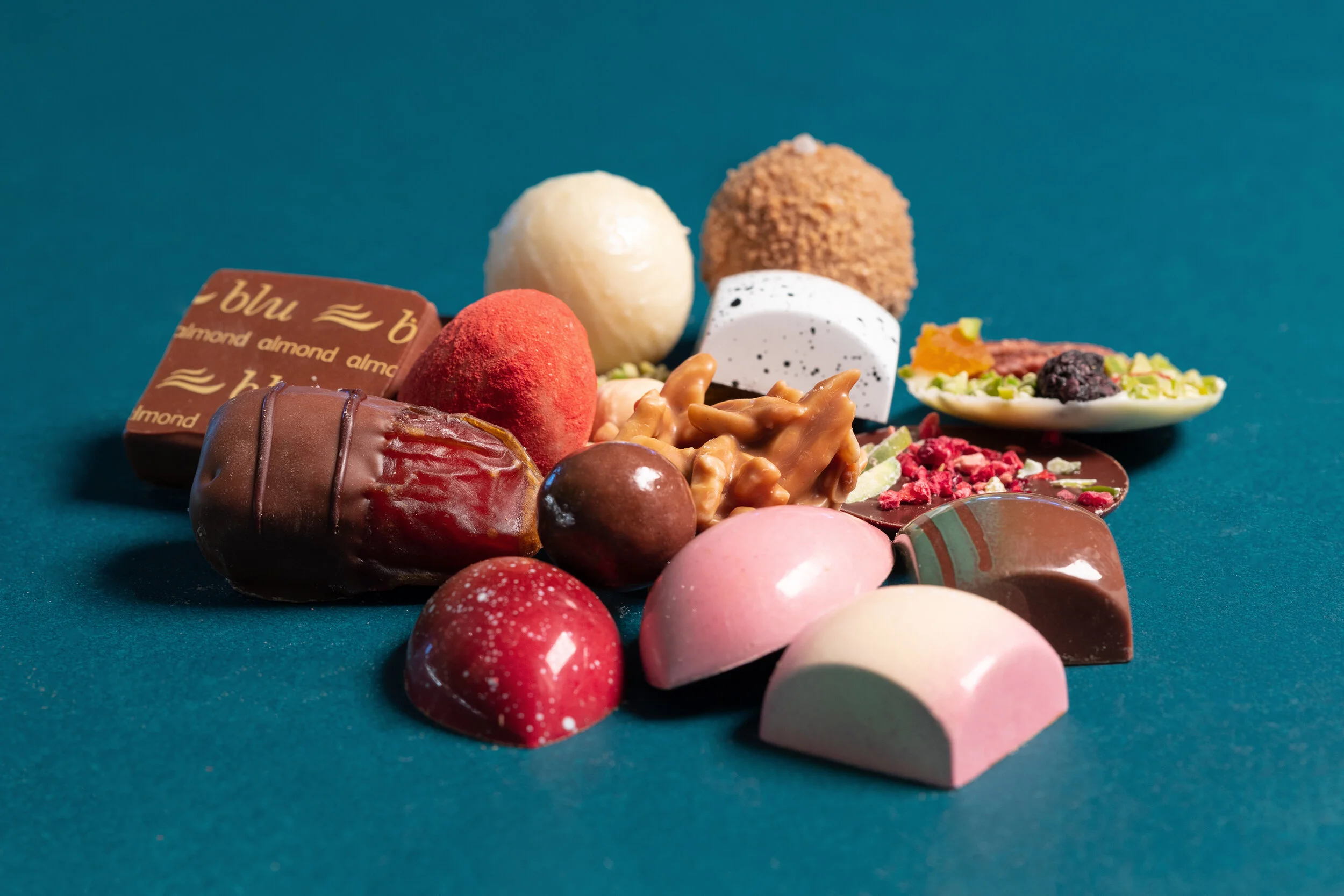 Assorted gourmet chocolates on a blue background