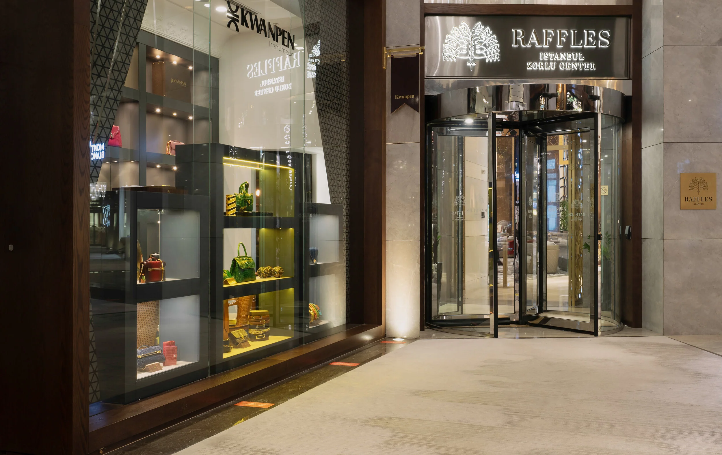 Entrance of Raffles Istanbul Zorlu Center with a display of luxury handbags by Kwanpen.