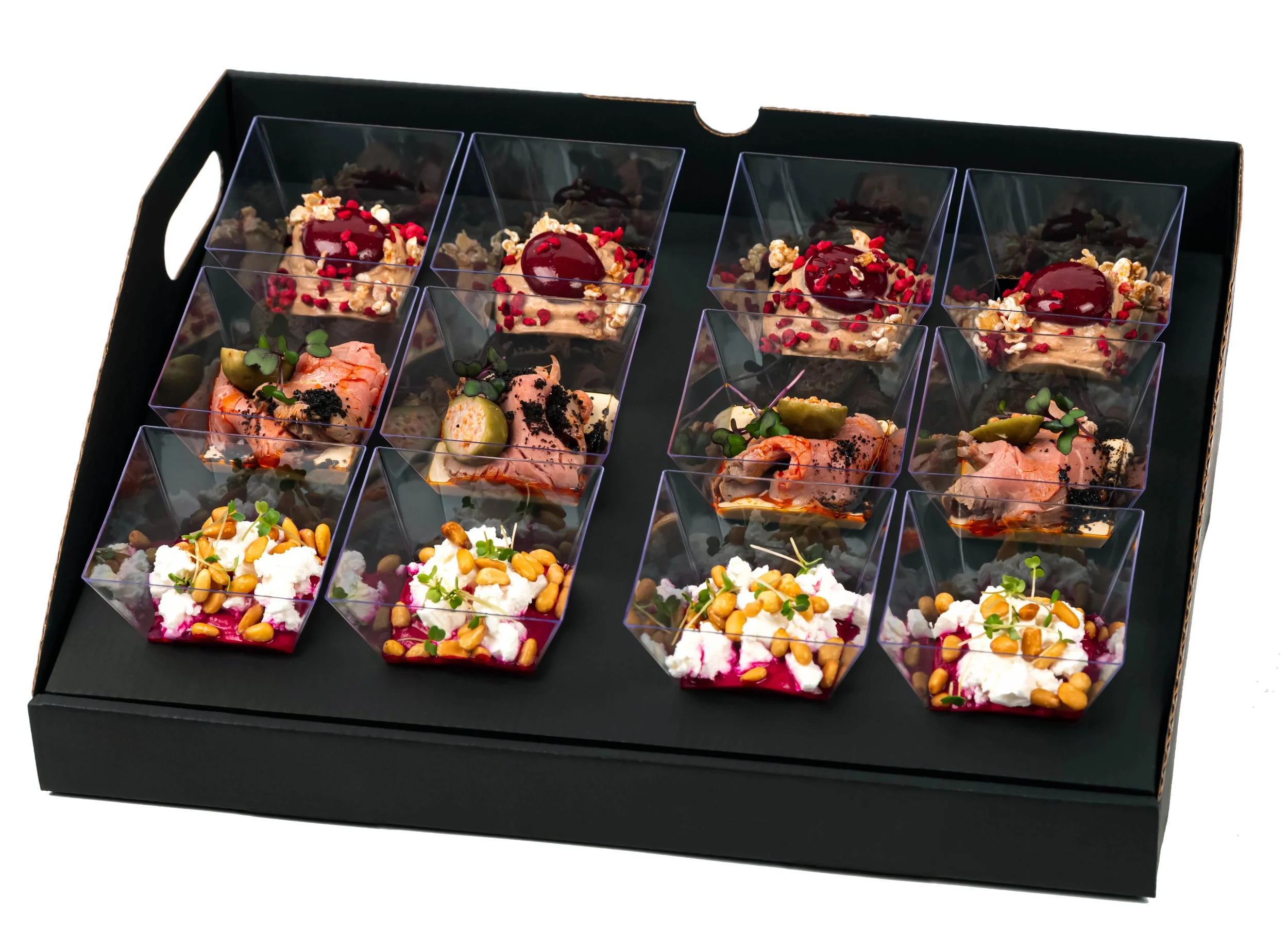 Assorted gourmet appetizers in a black tray, featuring items like smoked salmon, cheese, and garnished bites in clear cups.