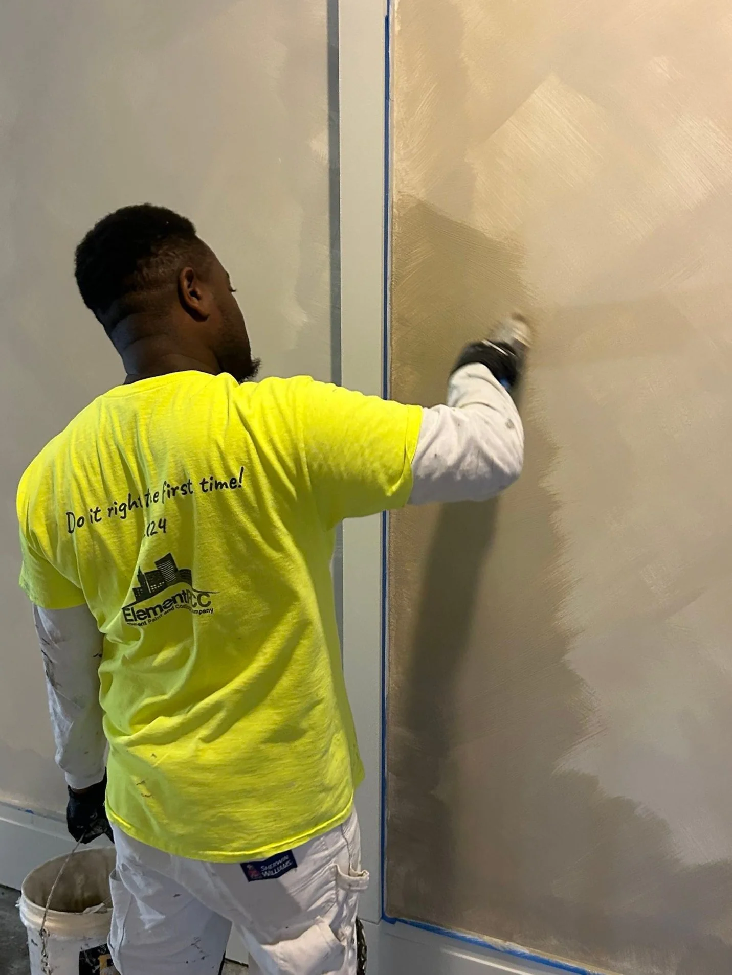 Painter applying limewash specialty finish in Seattle hotel