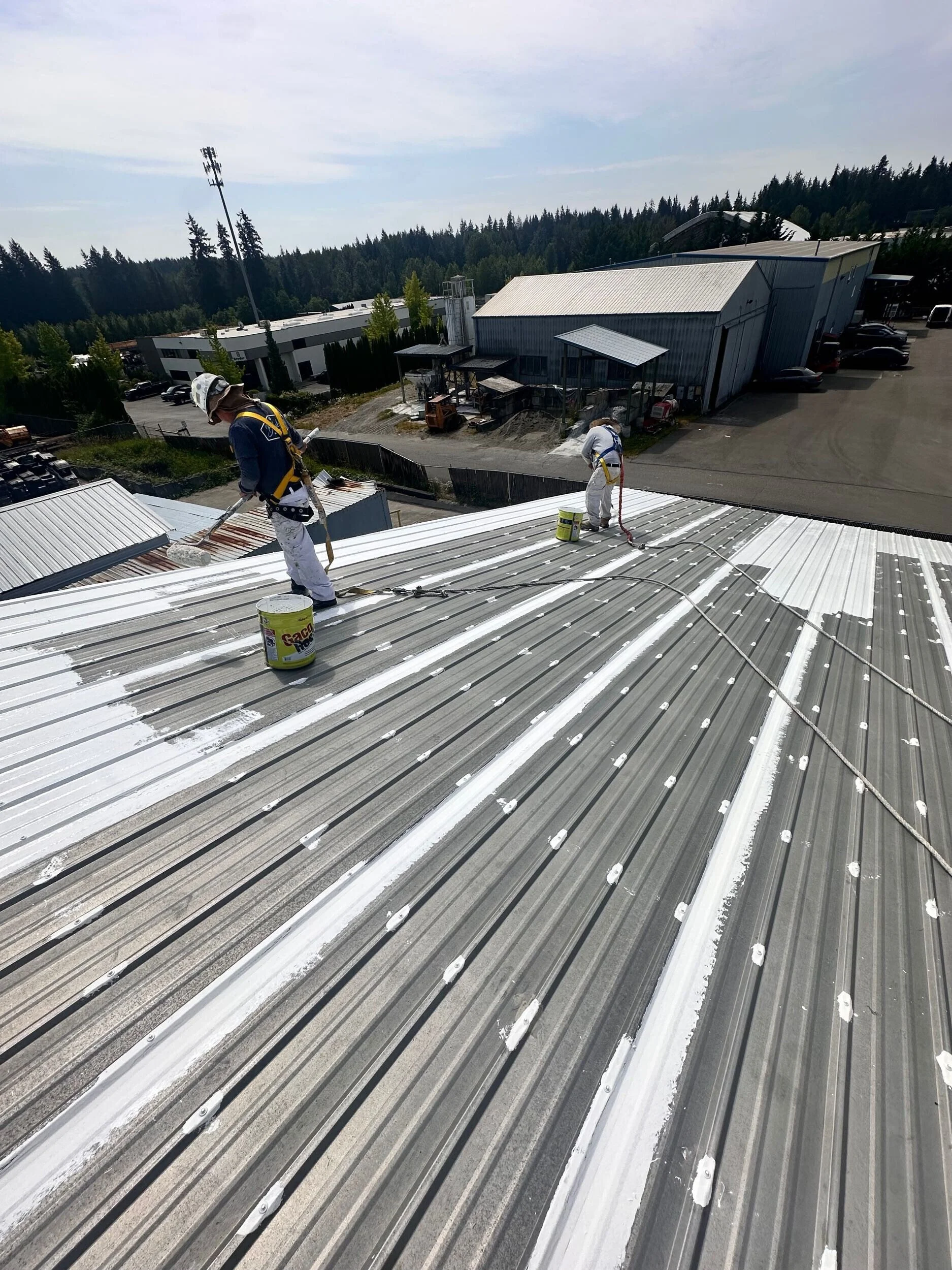 Commercial painters in Snohomish painting a metal warehouse roof