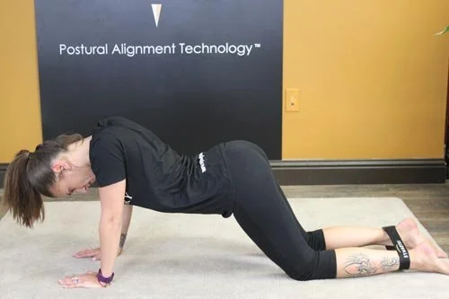 woman on the floor doing extended ankle abduction