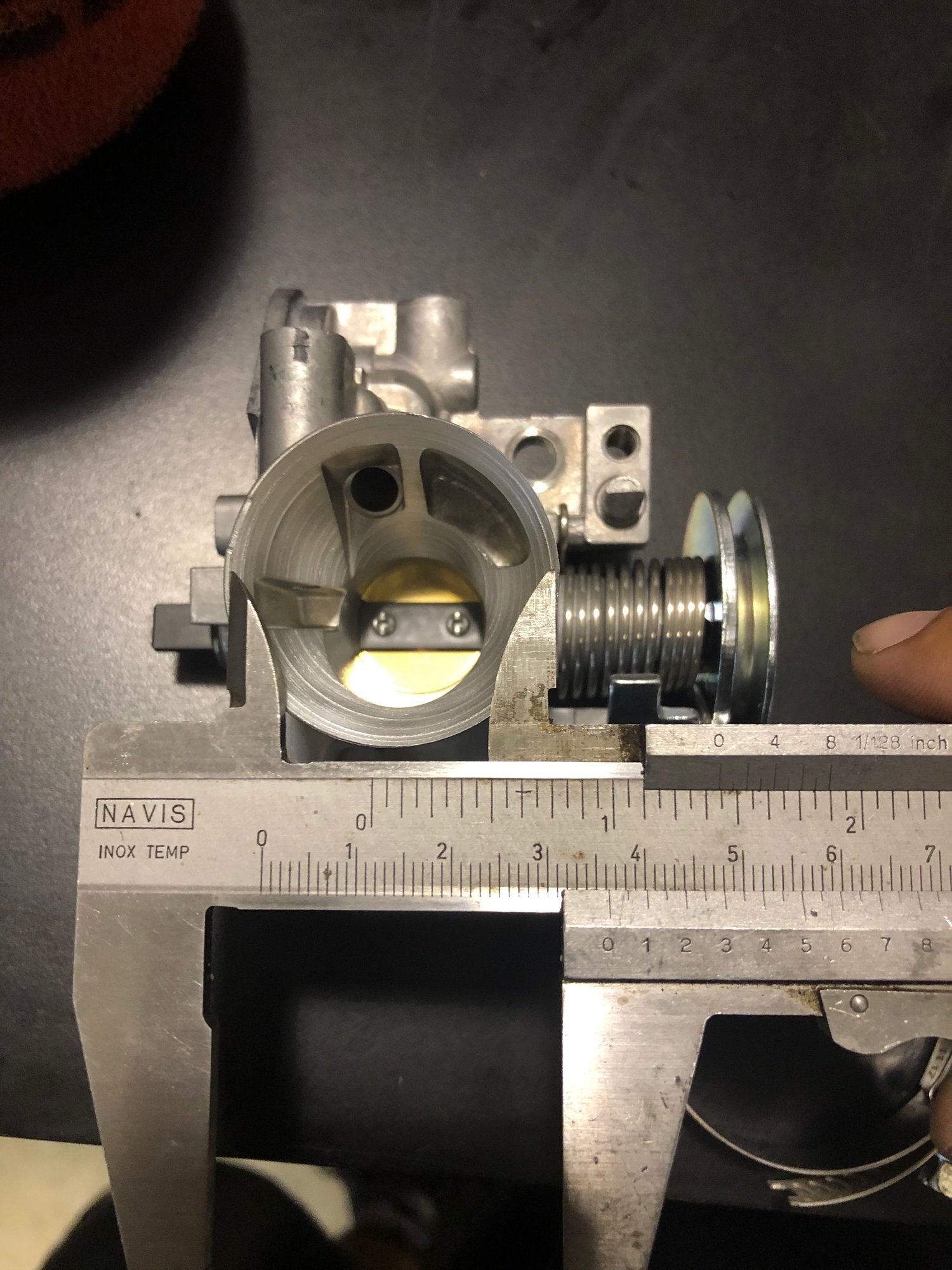 After separating the intake manifold from the throttle body, we found one of the biggest restrictions of the bike. - The stock intake manifold starts out at 24mm and works it’s way down to 13mm. It then widens back up to just over 20mm. We fix this …
