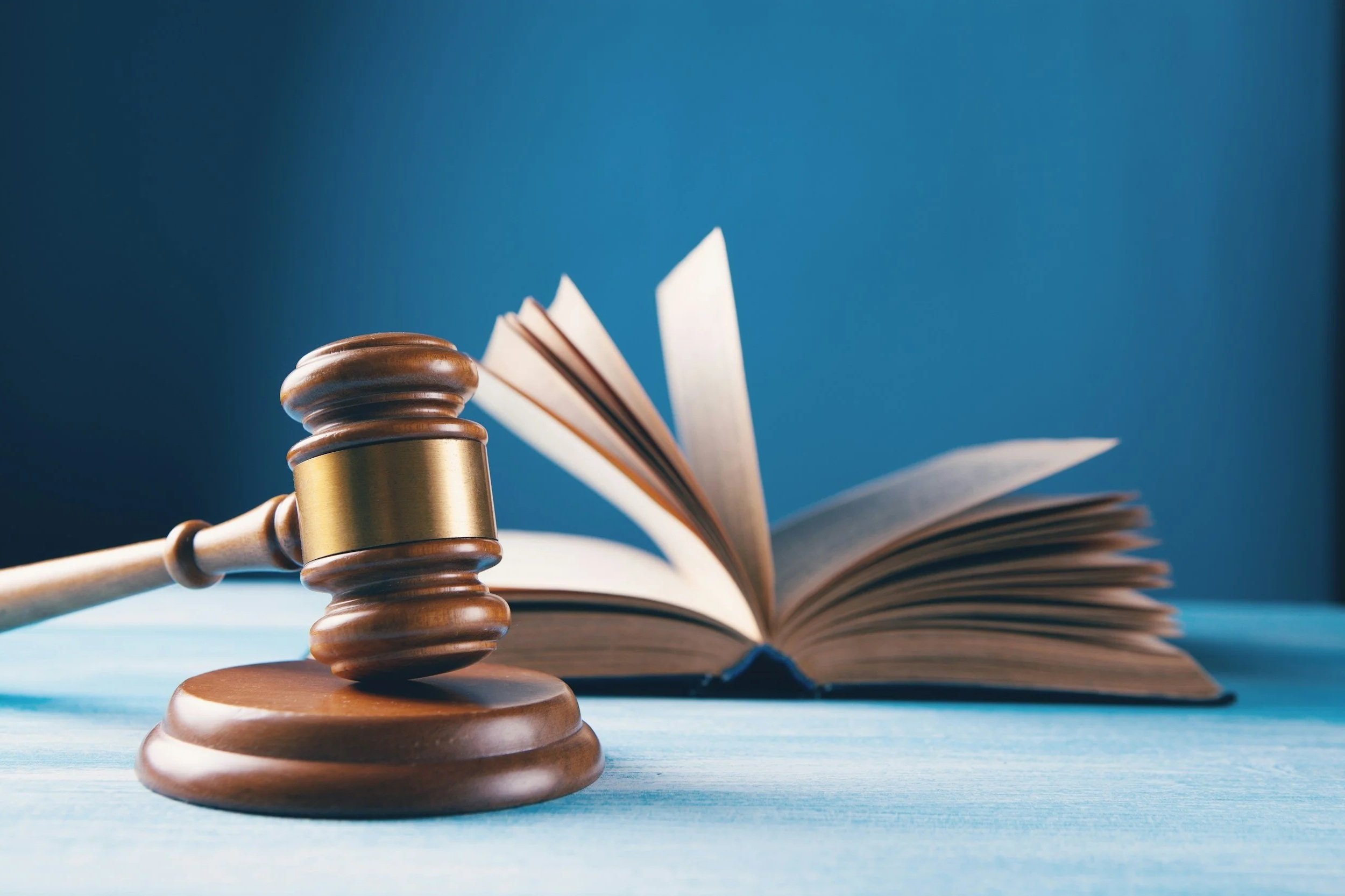 Gavel and legal text book blue background