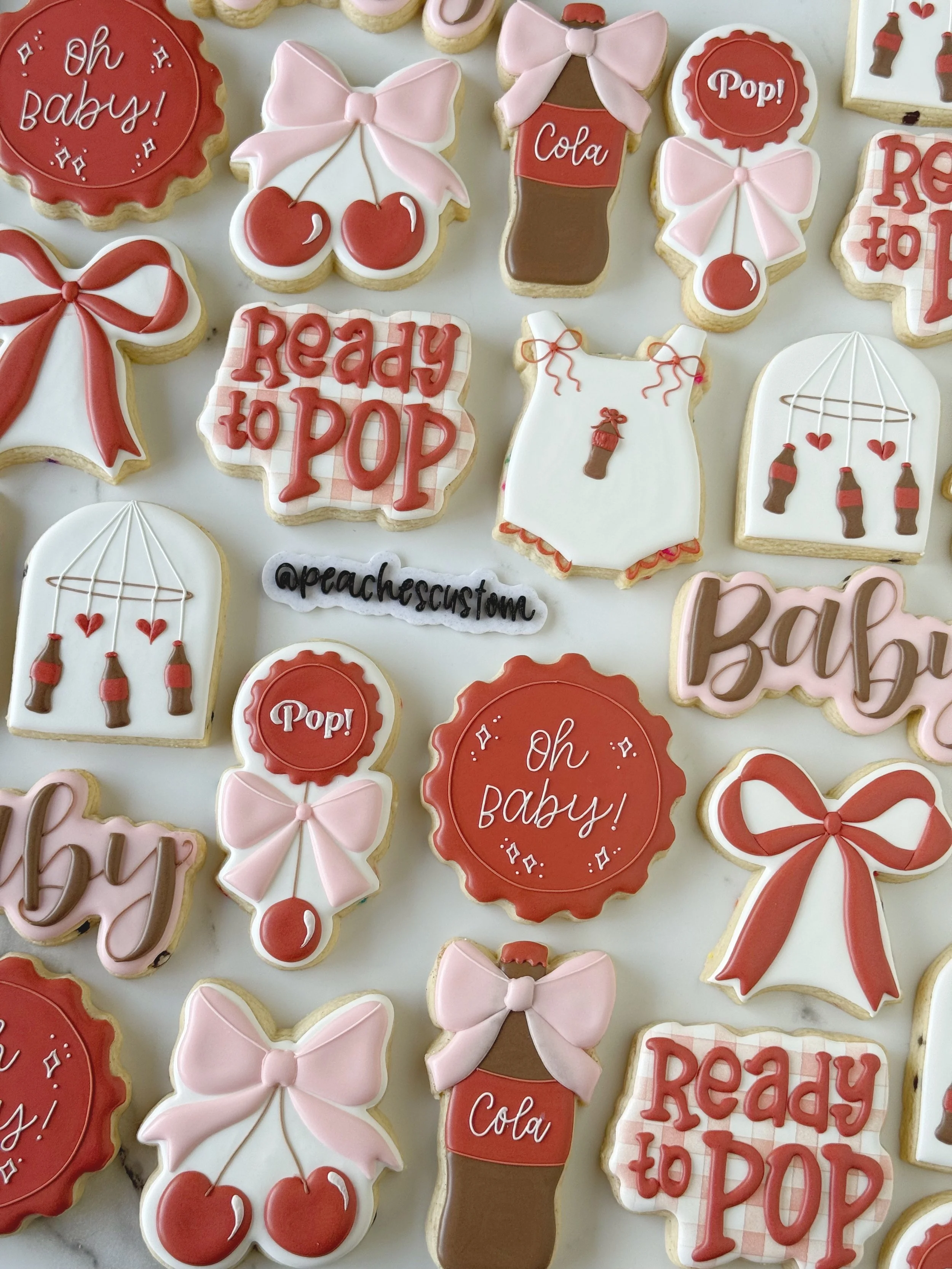 Assorted decorated cookies featuring names, the number 32, and images of champagne glasses and a dancing woman, themed for a celebration.