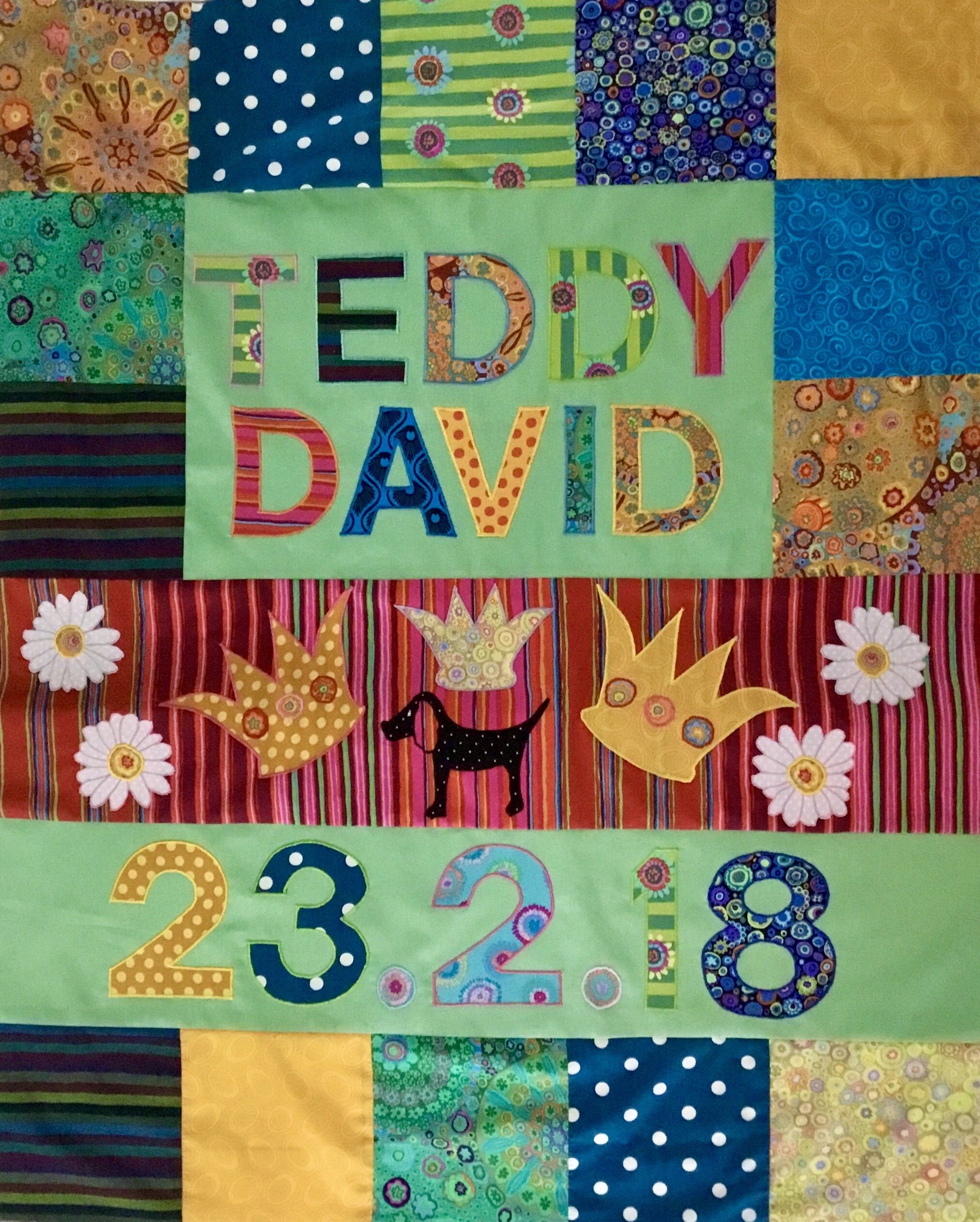 In this quilt I designed a family crest based on their pet dog and the surname 'King'. This is a cot size quilt.