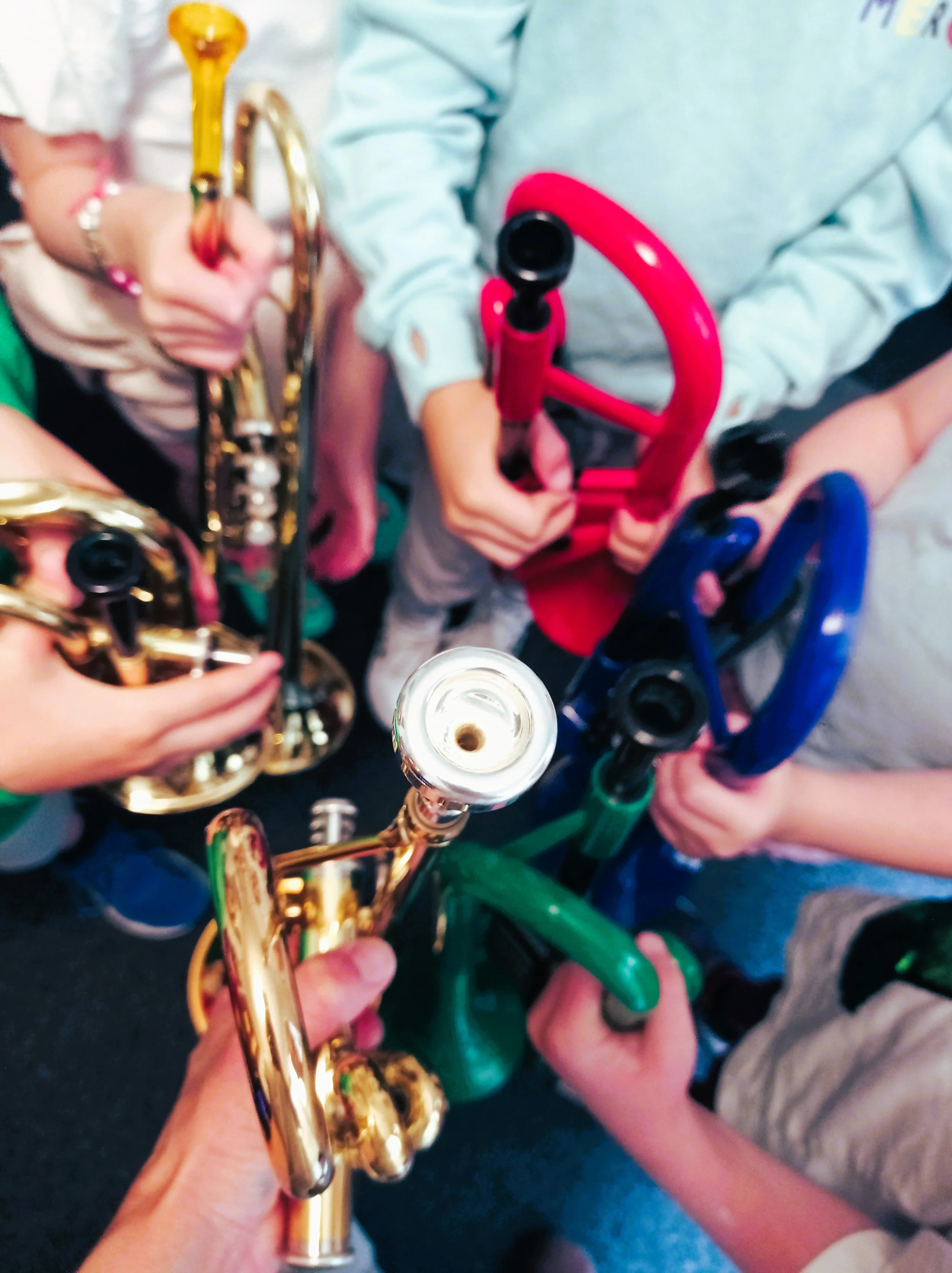 Trumpet mouthpieces and trumpets, gold, blue, red and green.