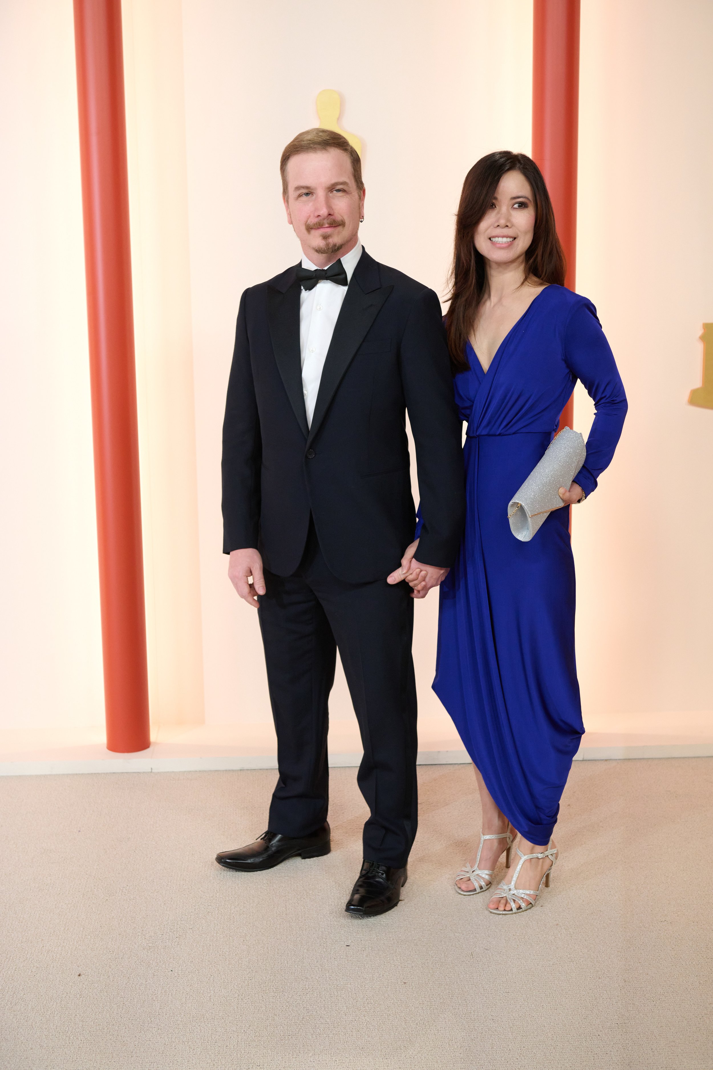 Oscar® nominee Adrien Morot and guest arrive on the red carpet of The 95th Oscars