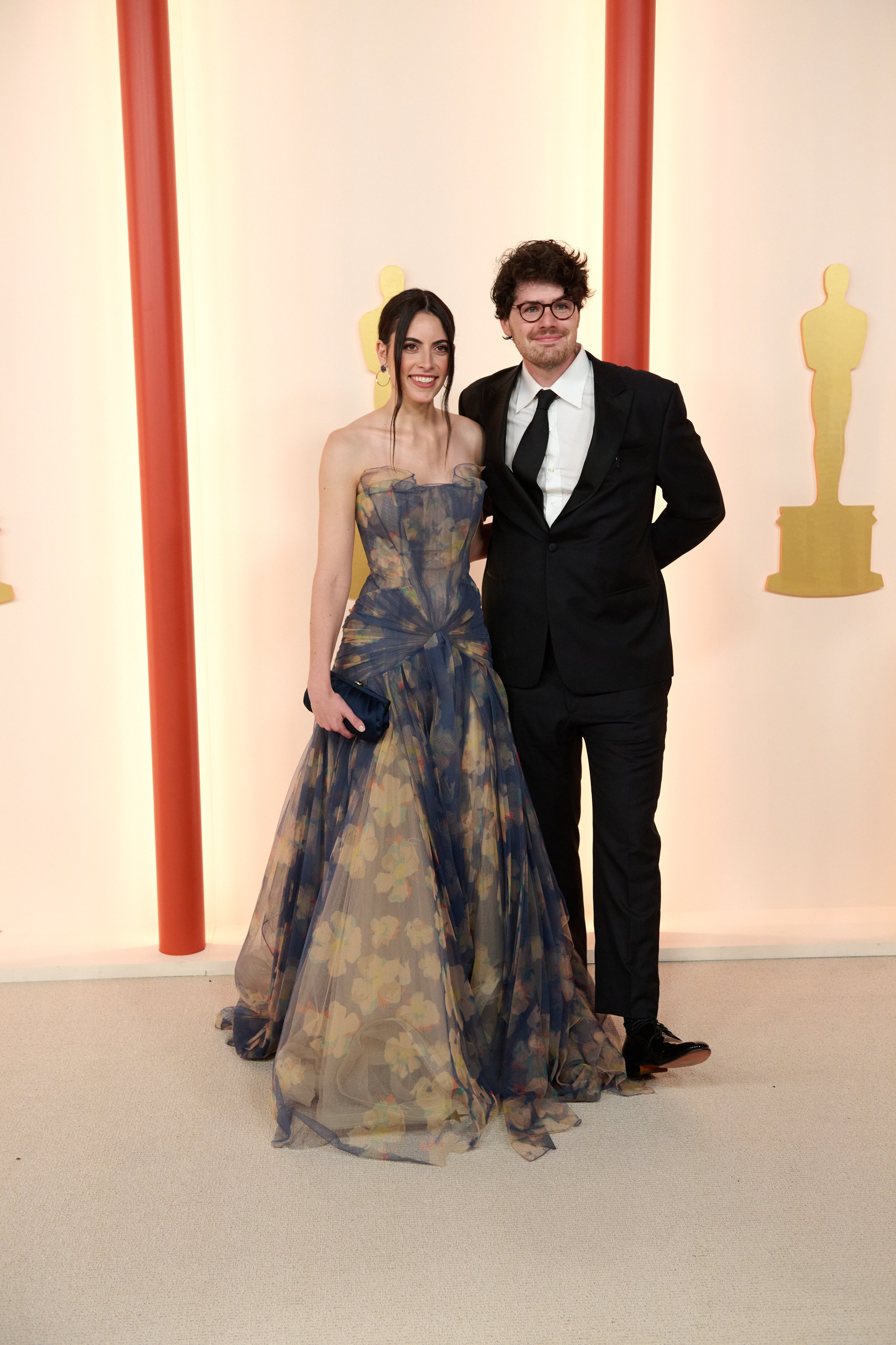 Caroline Lindy and Daniel Roher arrive on the red carpet of the 95th Oscars
