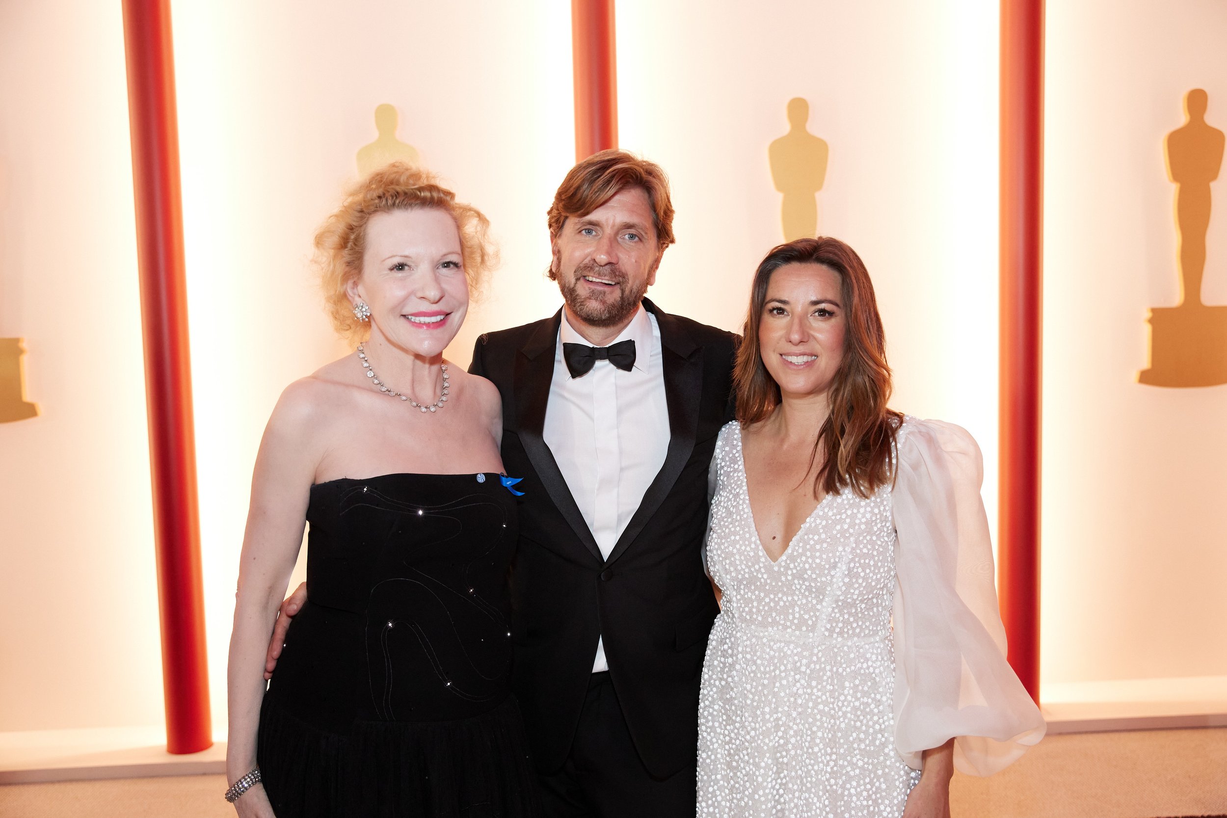 Oscar® nominee Ruben Östlund arrives with Sunnyi Melles and guest on the red carpet of The 95th Oscars
