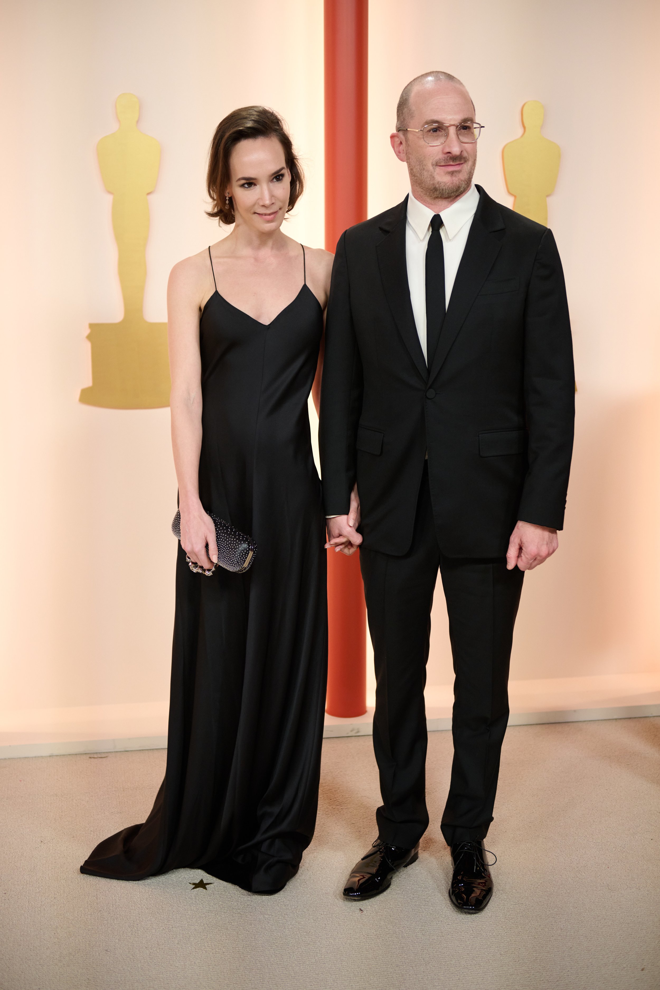 Darren Aronofsky arrives with guest on the red carpet of The 95th Oscars