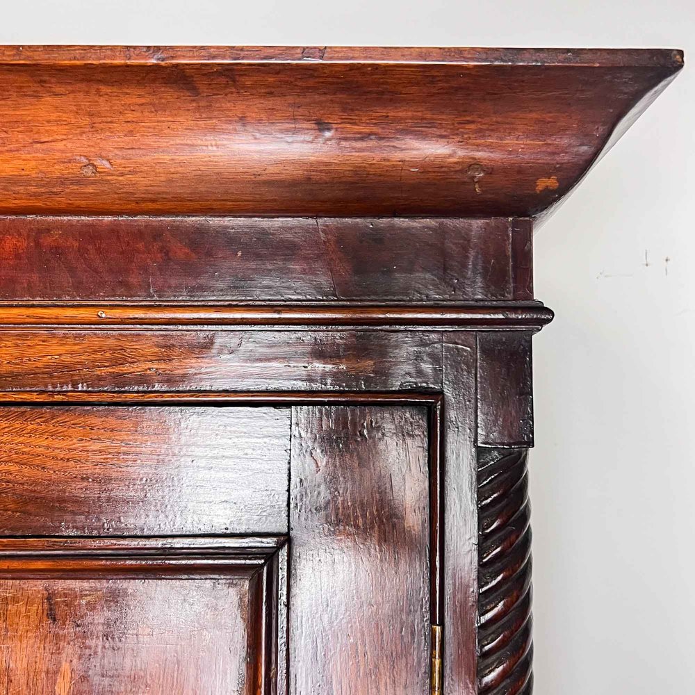 A 19thC mahogany corner cupboard, with moulded top and cross