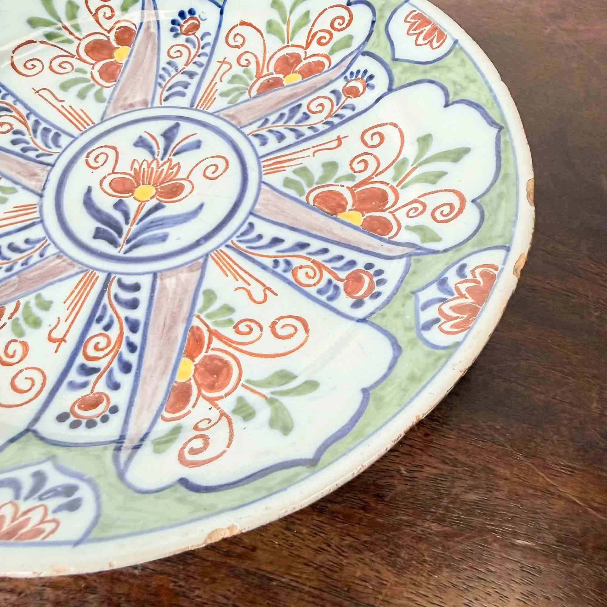 antique polychrome delft plate with green background