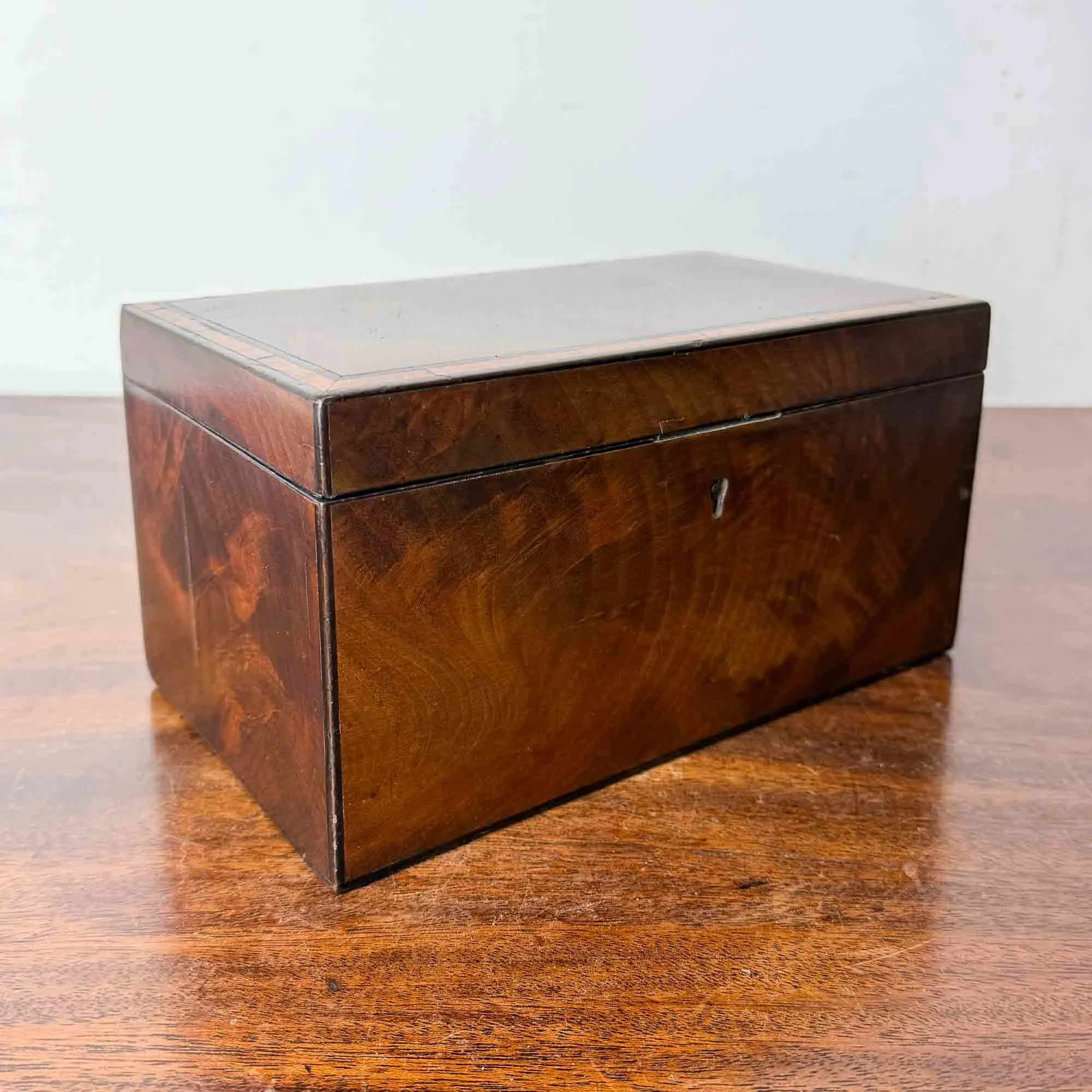 antique flame mahogany tea caddy with ebony inlay