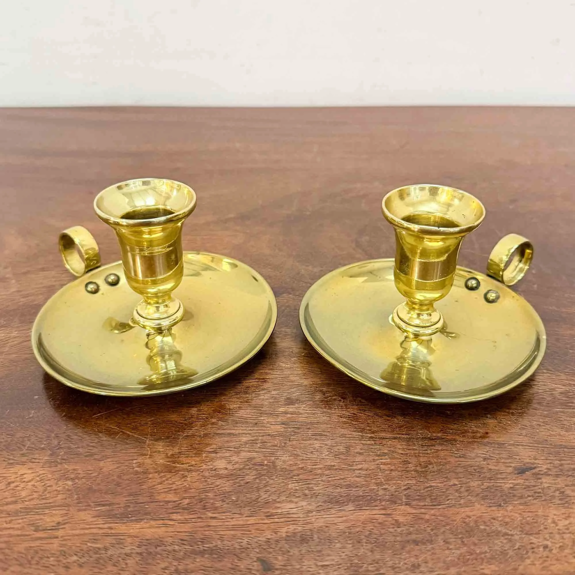 pair of antique brass chambersticks