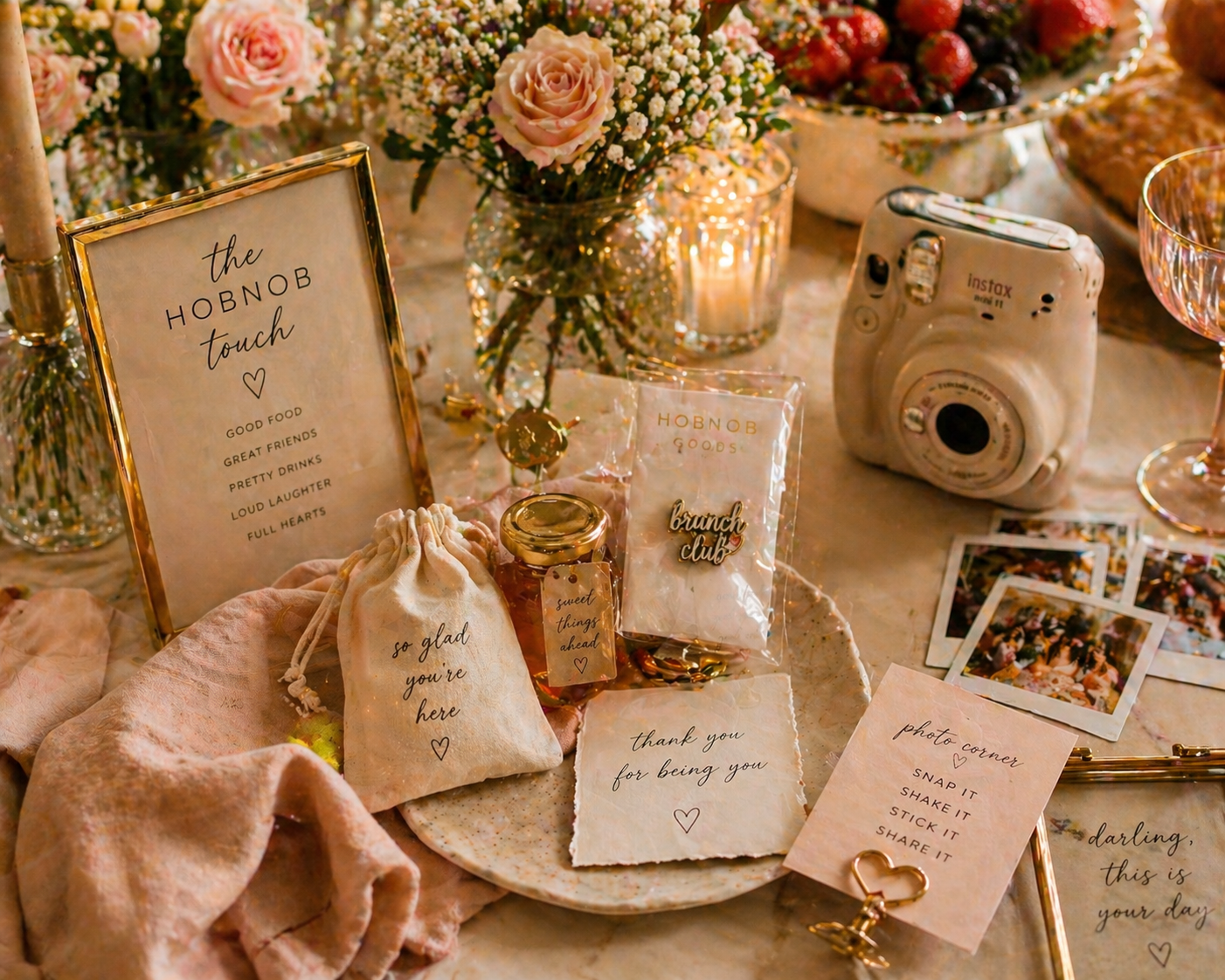hobnob lifestyle brunch details with enamel pin polaroid camera and party favors