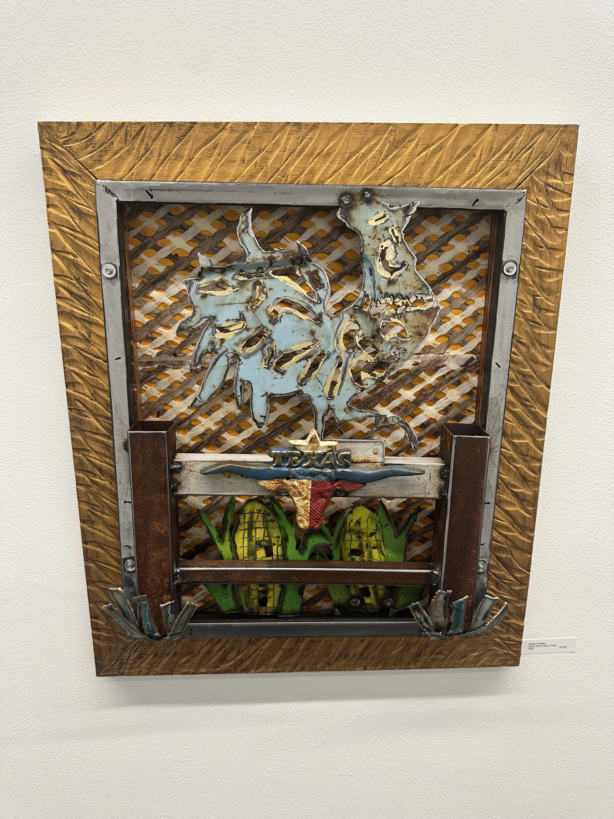 Mixed media artwork featuring a metal sculpture of a horse's head, a Texas-themed sign, and yellow corn cobs, all mounted on a decorative wooden frame.