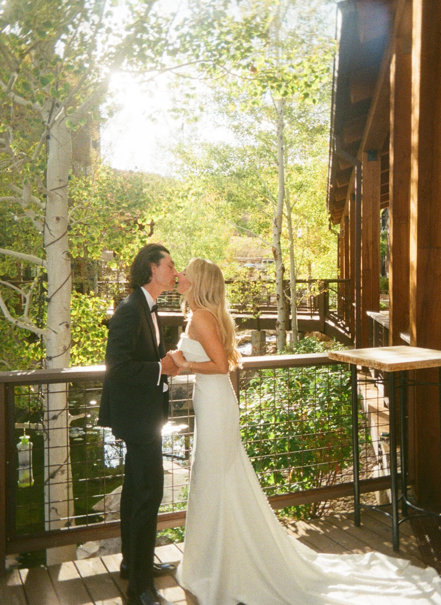 High West Distillery Wedding Film Photography near Park City featured in rocky mountain bride magazine couple embracing a kiss for their first look.